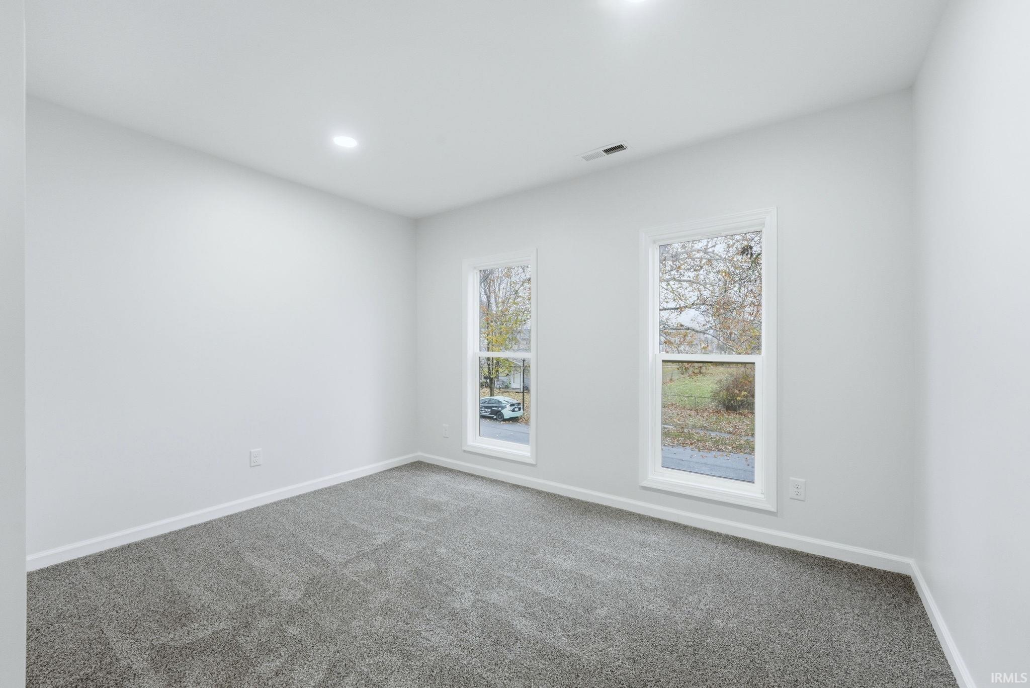 Spare room with carpet floors and recessed lighting