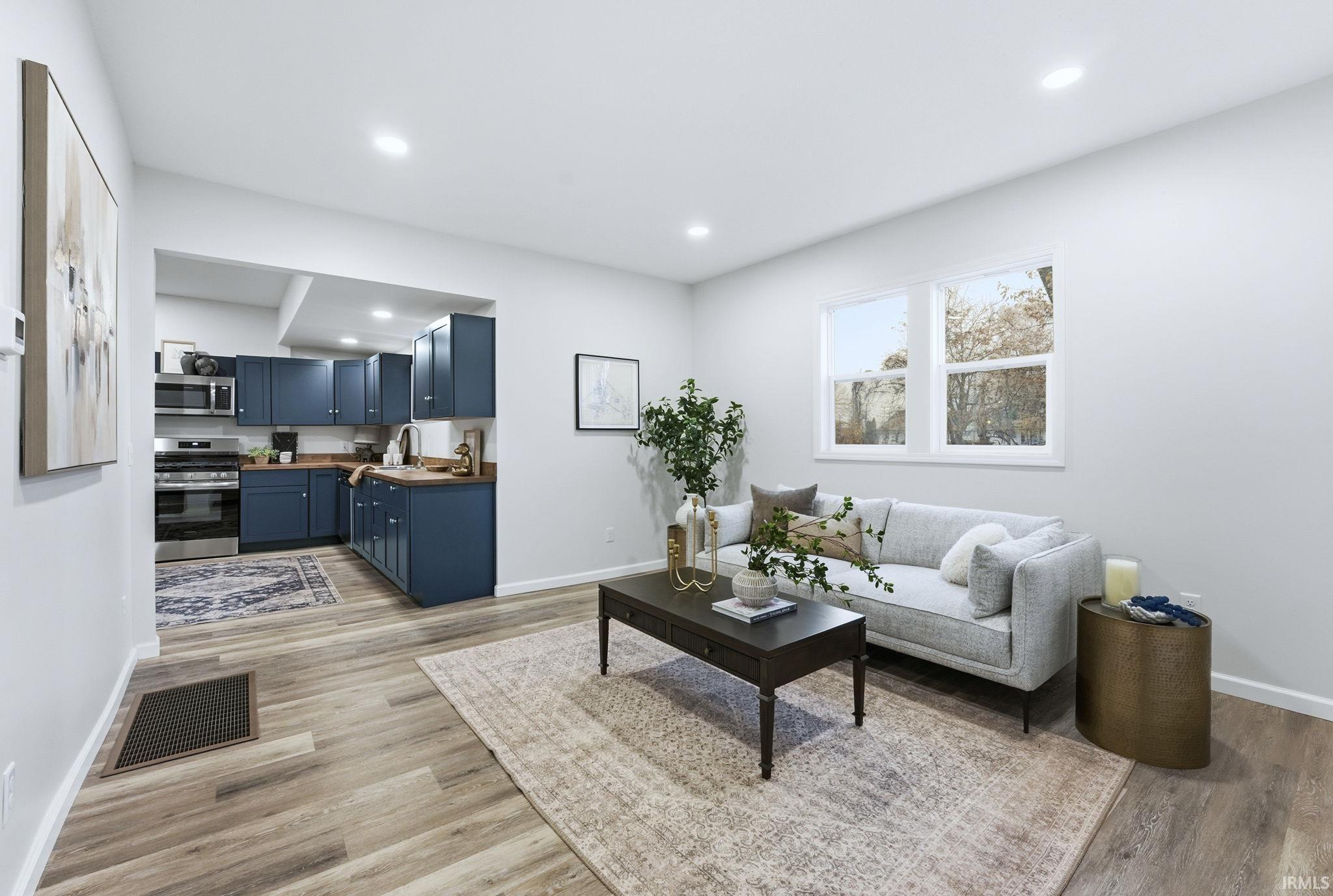 Living area featuring recessed lighting and light wood-type flooring