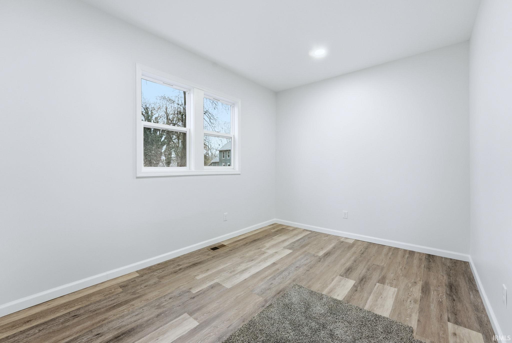 Unfurnished room with light wood-type flooring