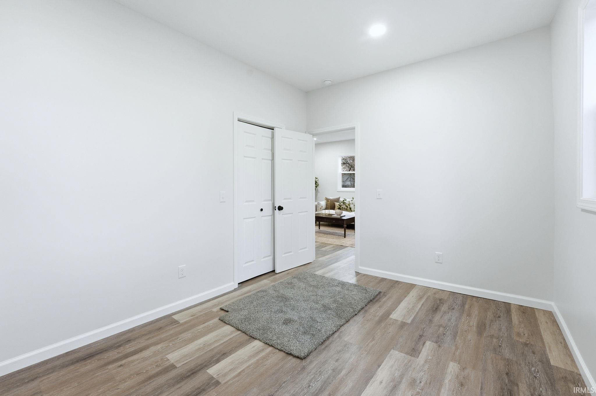 Unfurnished room featuring light wood-style floors and baseboards