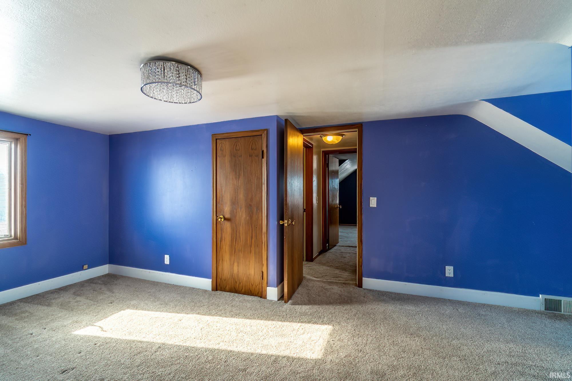 Additional living space with carpet and baseboards