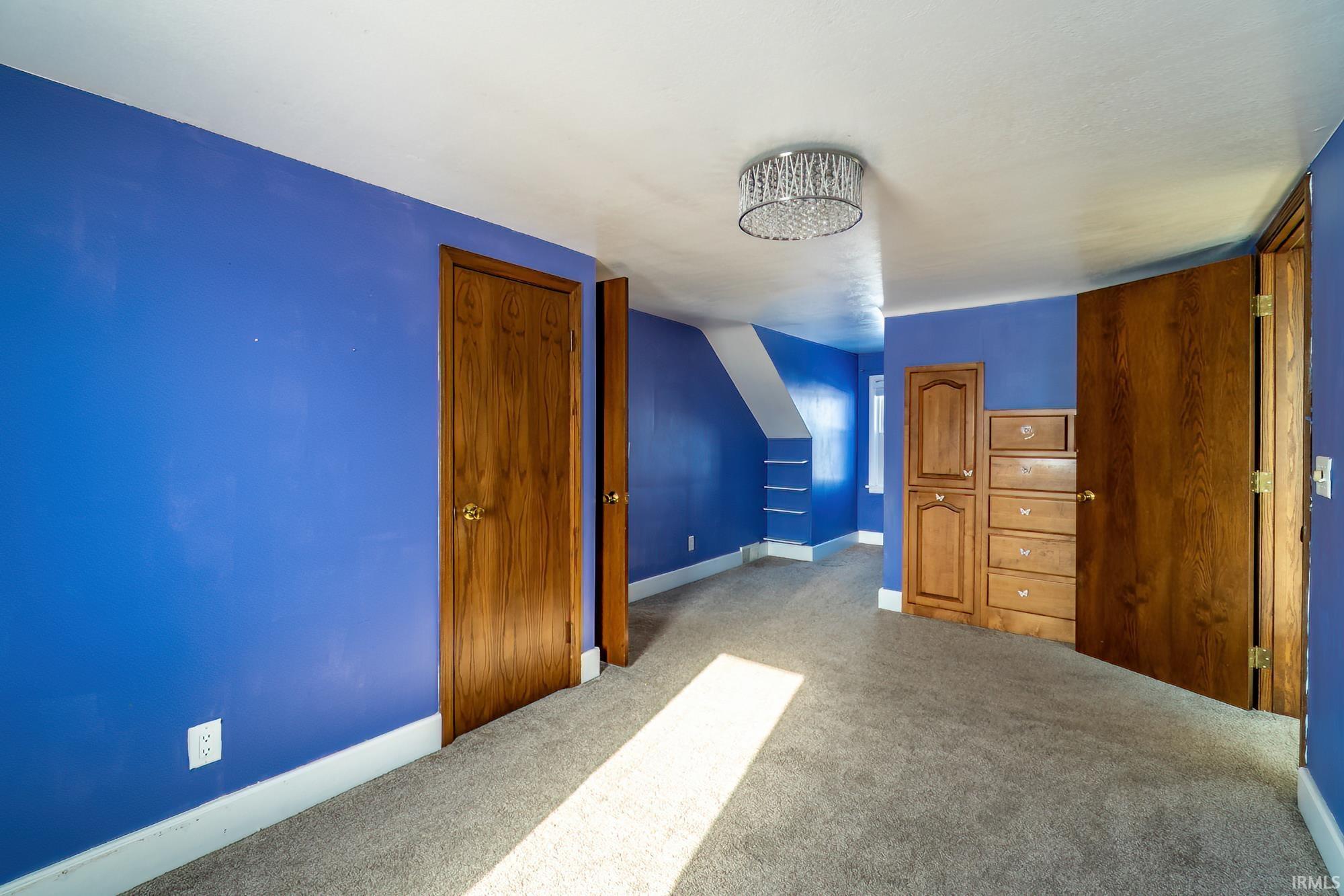 Additional living space featuring carpet floors and baseboards