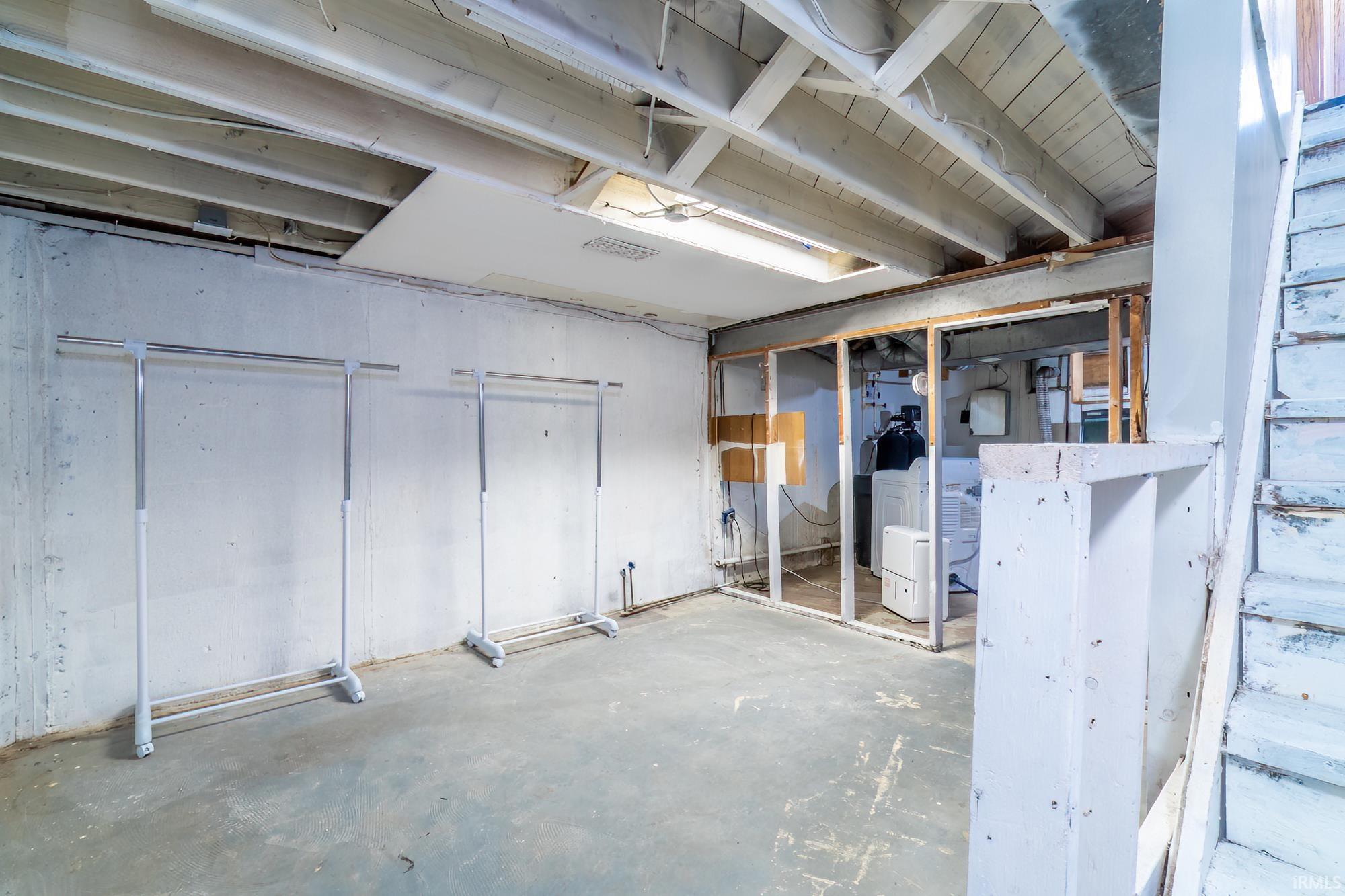 Unfinished basement with washer / clothes dryer