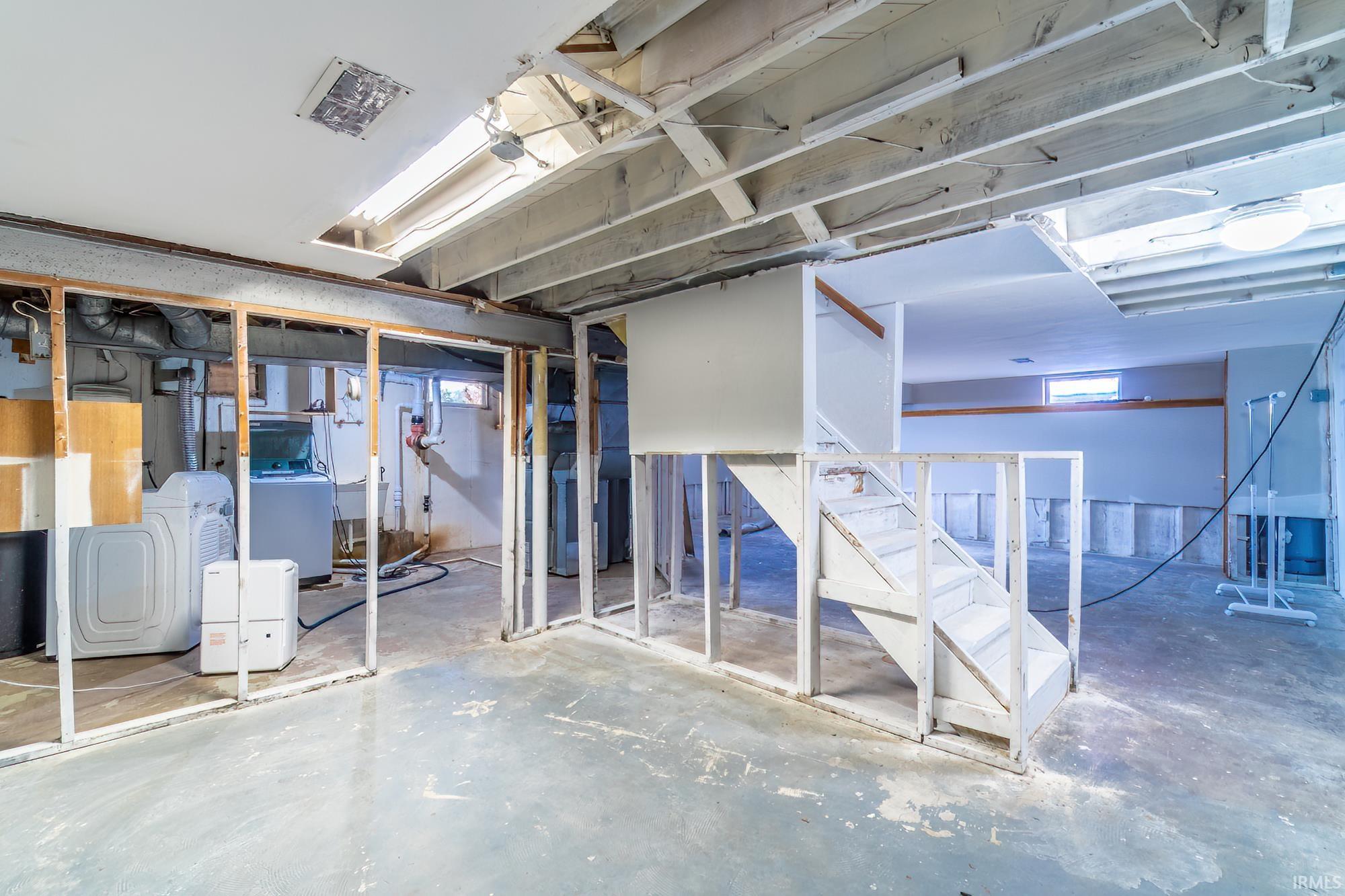 Basement with stairs and washing machine and clothes dryer