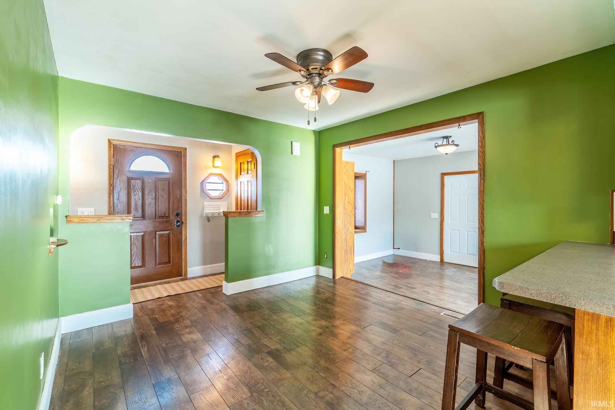 Foyer entrance featuring dark wood finished floors and a ceiling fan