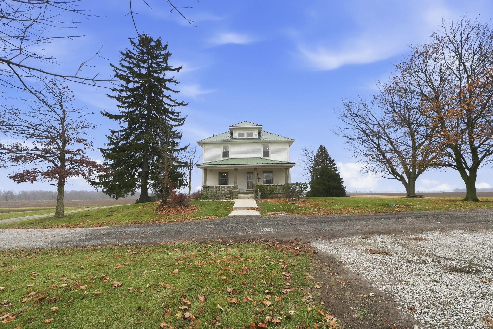 View of front of property with a porch and a front lawn