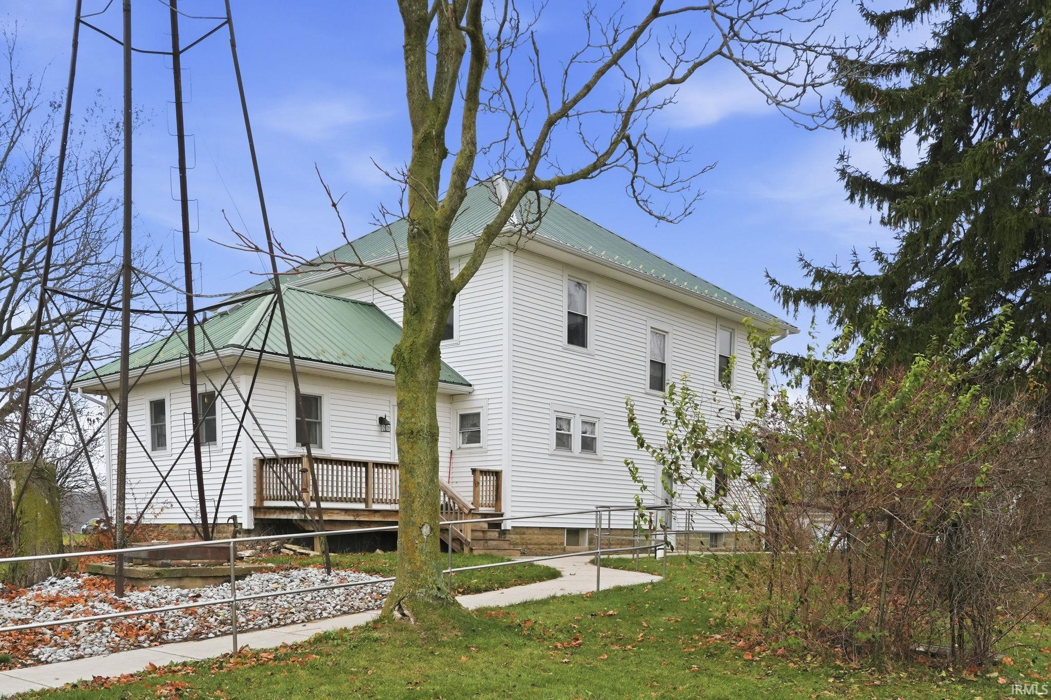 Rear view of house featuring a yard and a deck