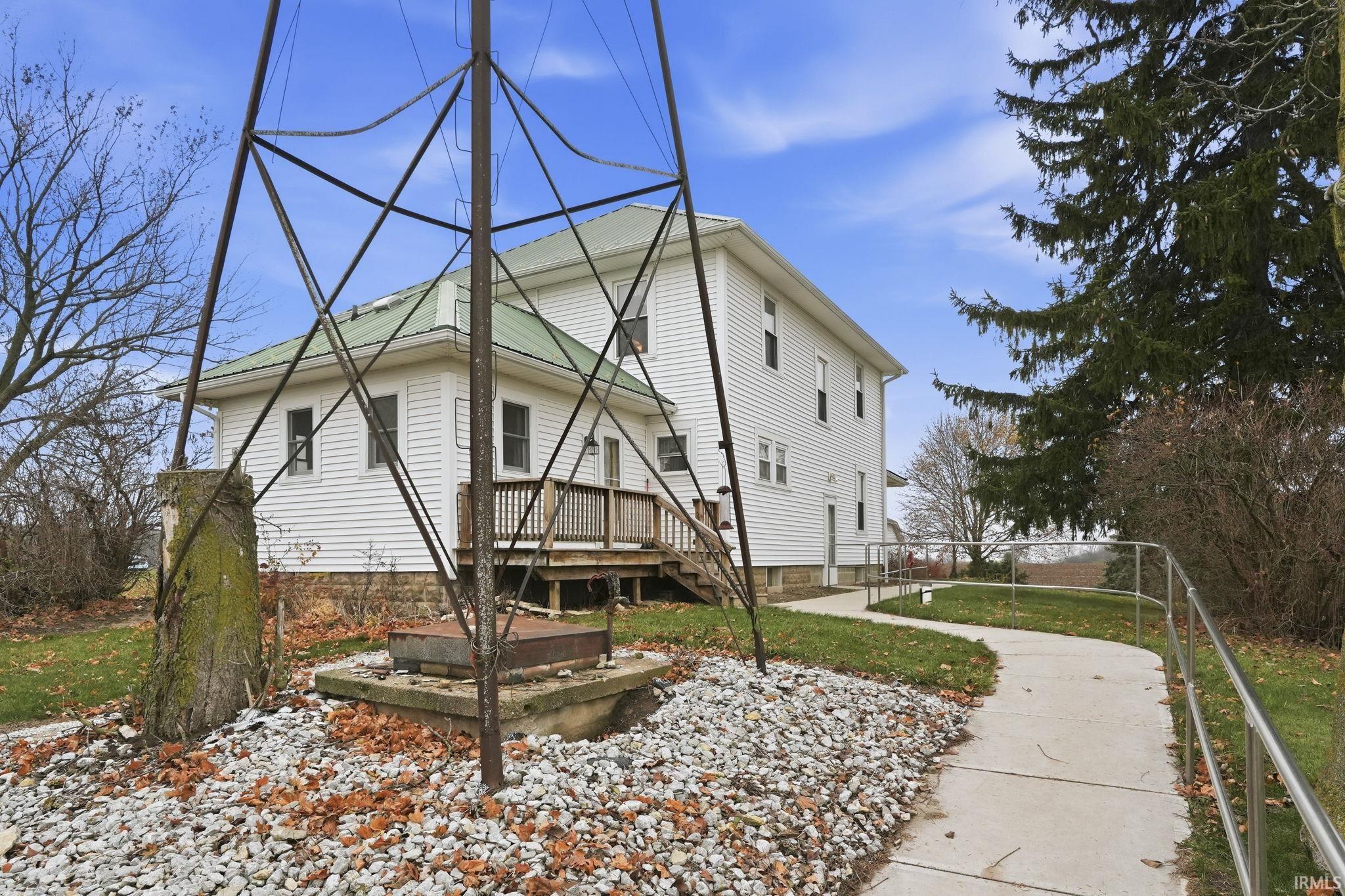 Rear view of house featuring a yard