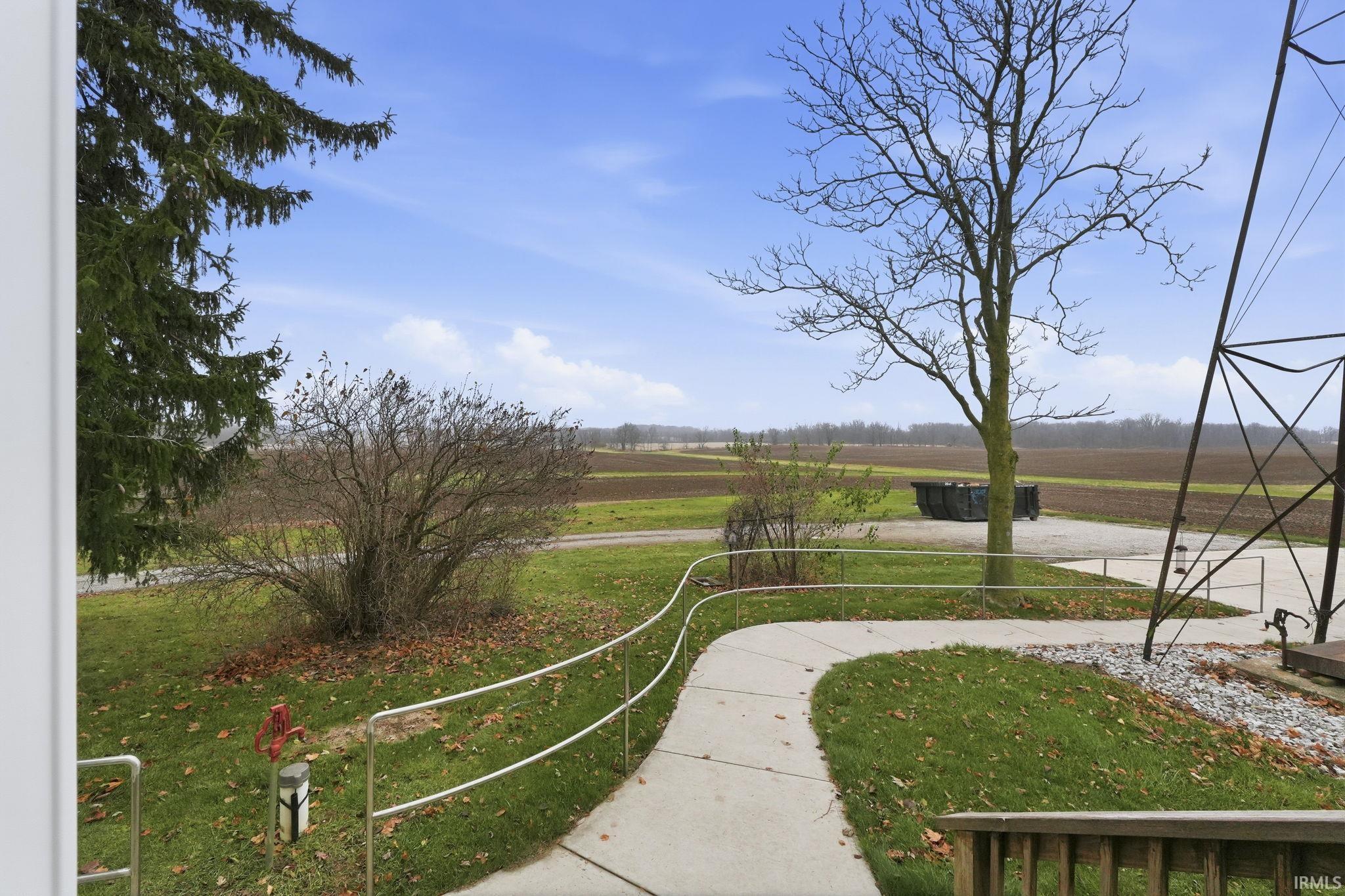 View of community with a lawn and a view of rural / pastoral area