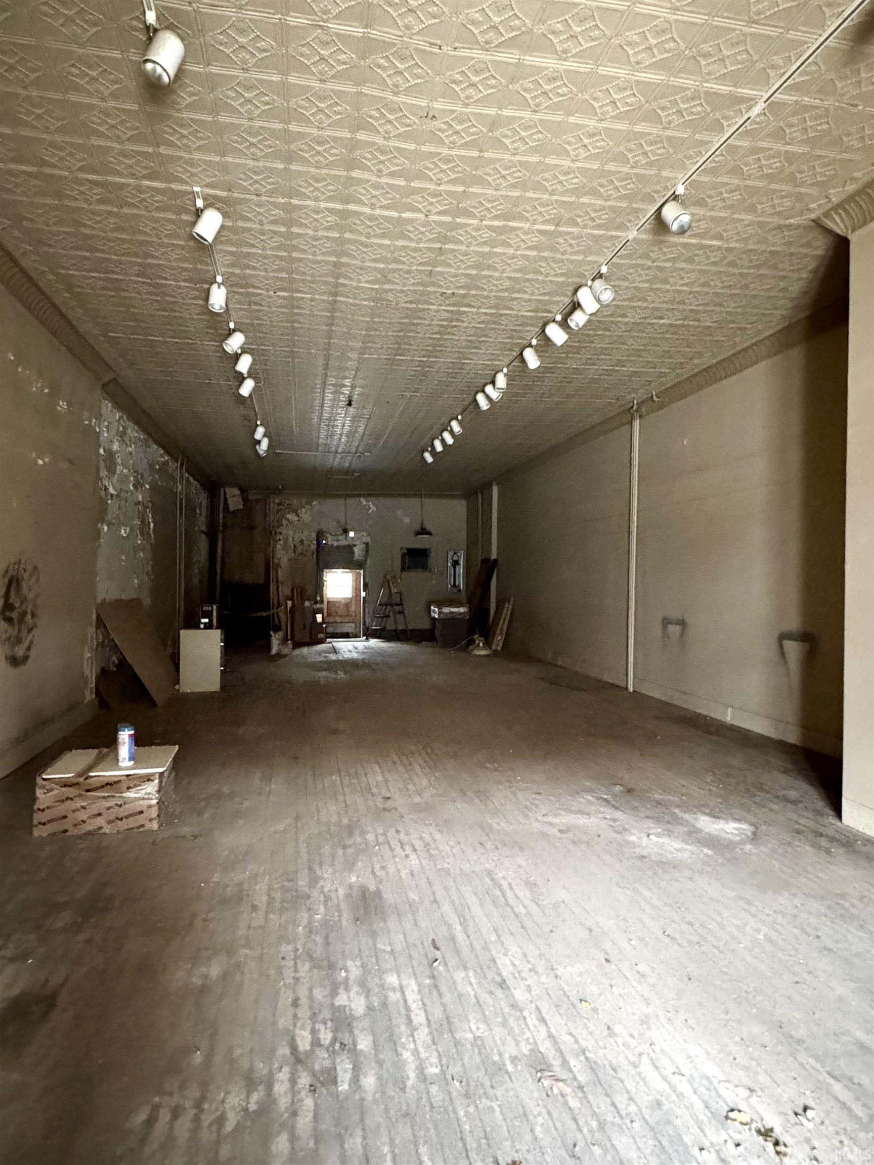 Misc room featuring hardwood / wood-style flooring and an ornate ceiling