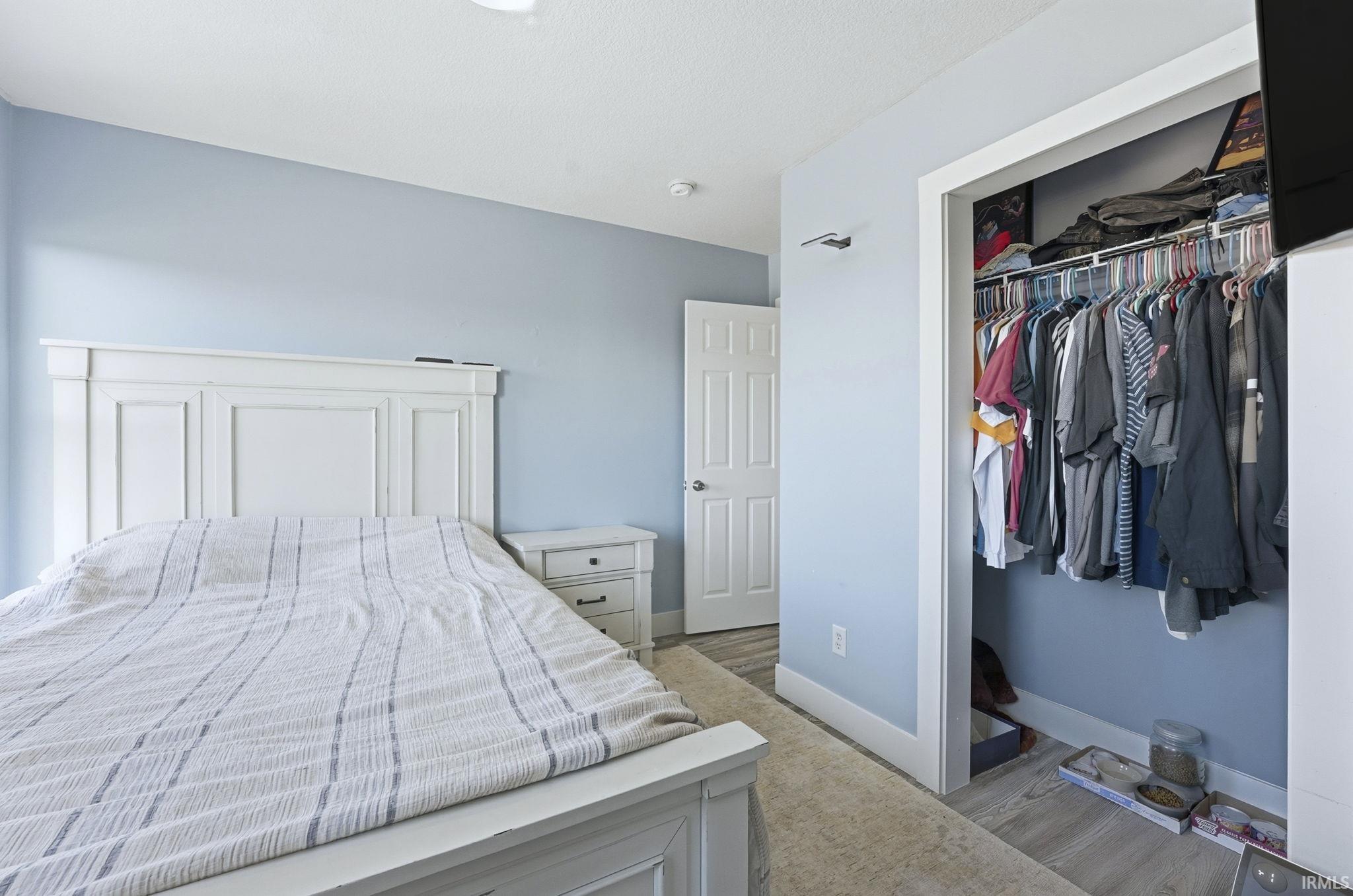 Bedroom featuring light wood finished floors and a closet