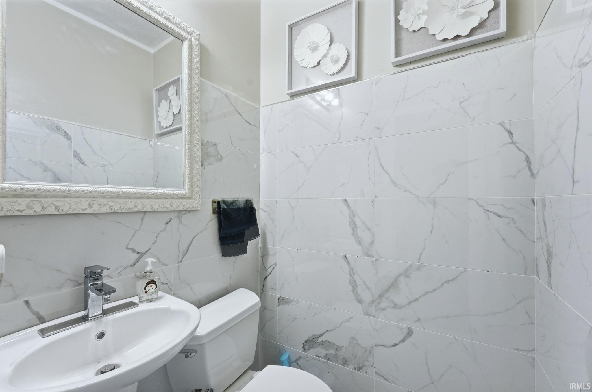 Bathroom with a sink and tile walls