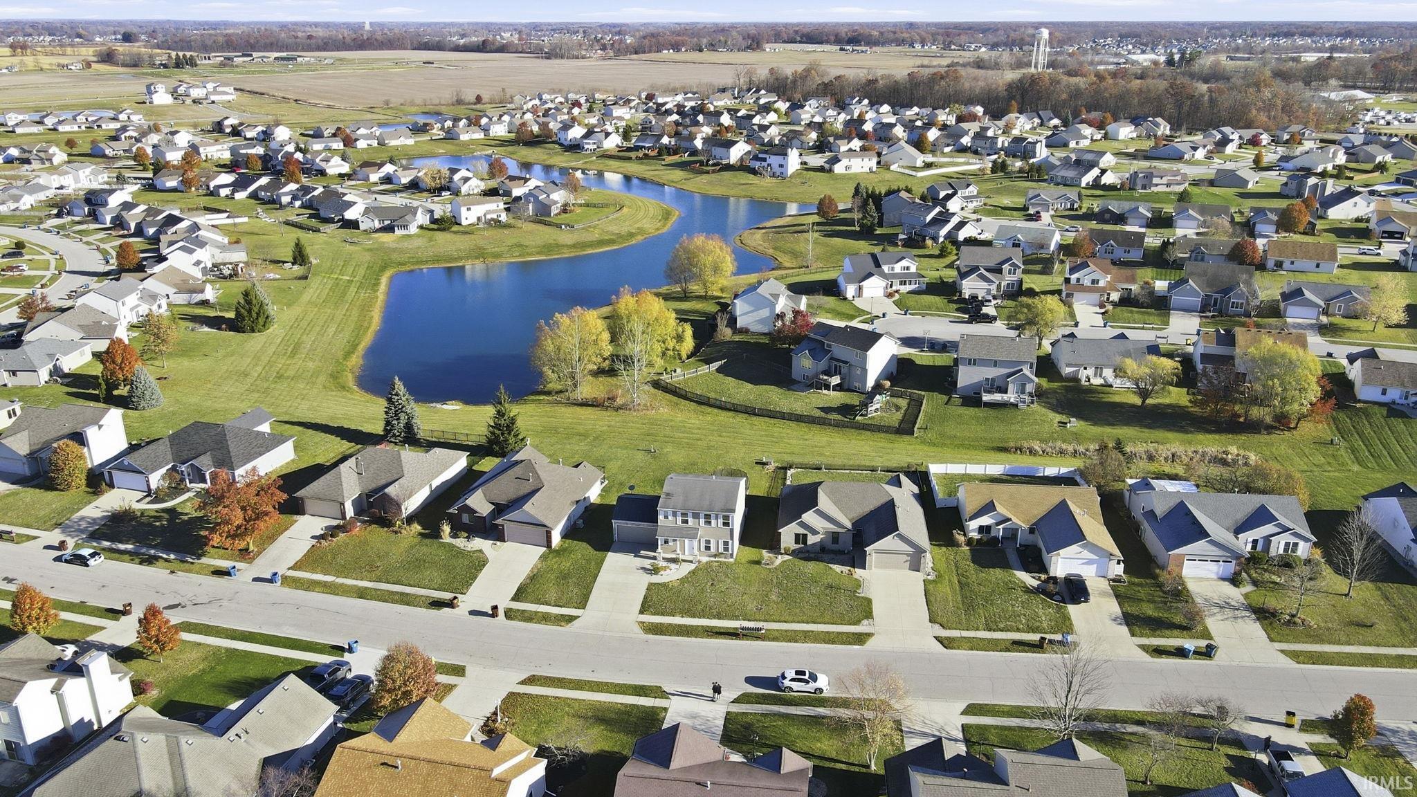 Aerial overview of property's location featuring a large body of water and nearby suburban area