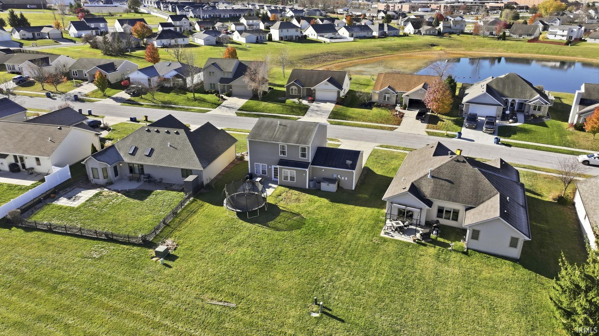 Aerial view of property's location featuring nearby suburban area and a nearby body of water