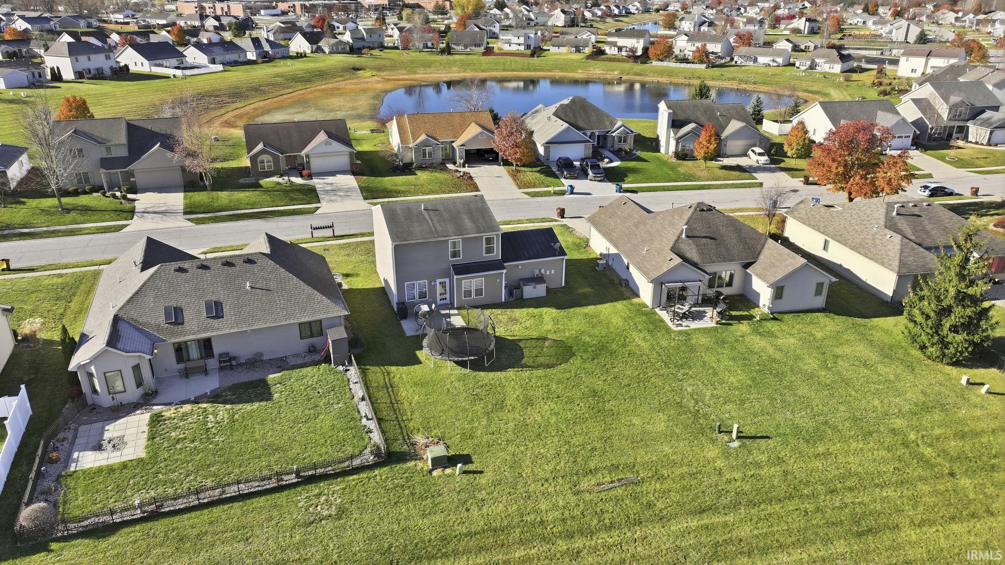 Aerial perspective of suburban area with a large body of water