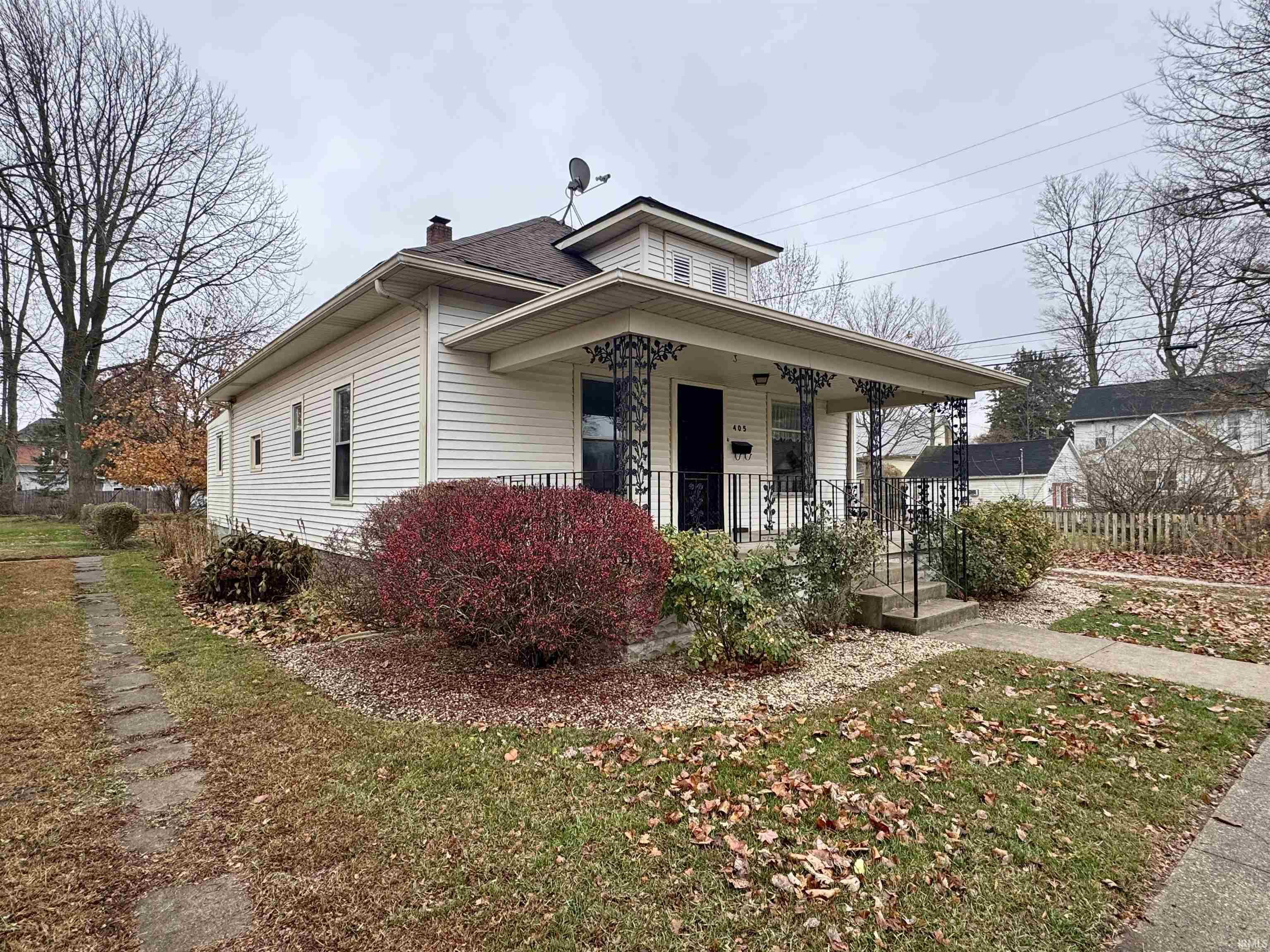 View of front of home with a porch and a chimney