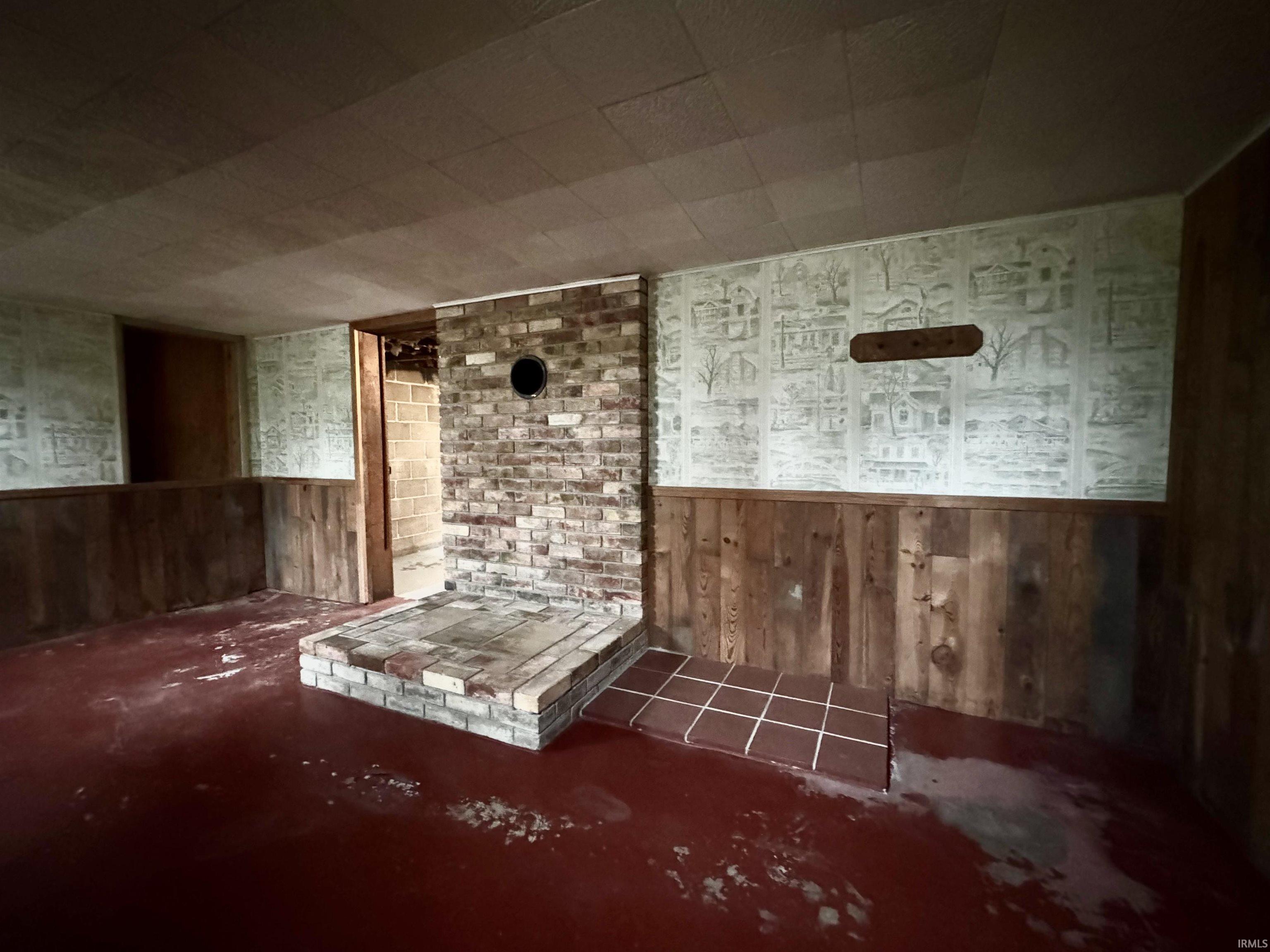 Basement with wood walls and a wainscoted wall