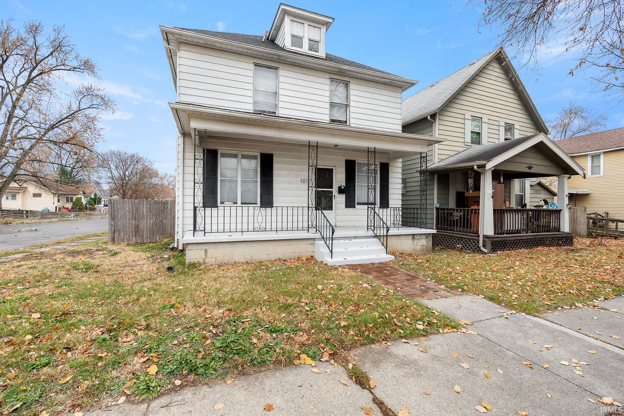 American foursquare style home with a porch