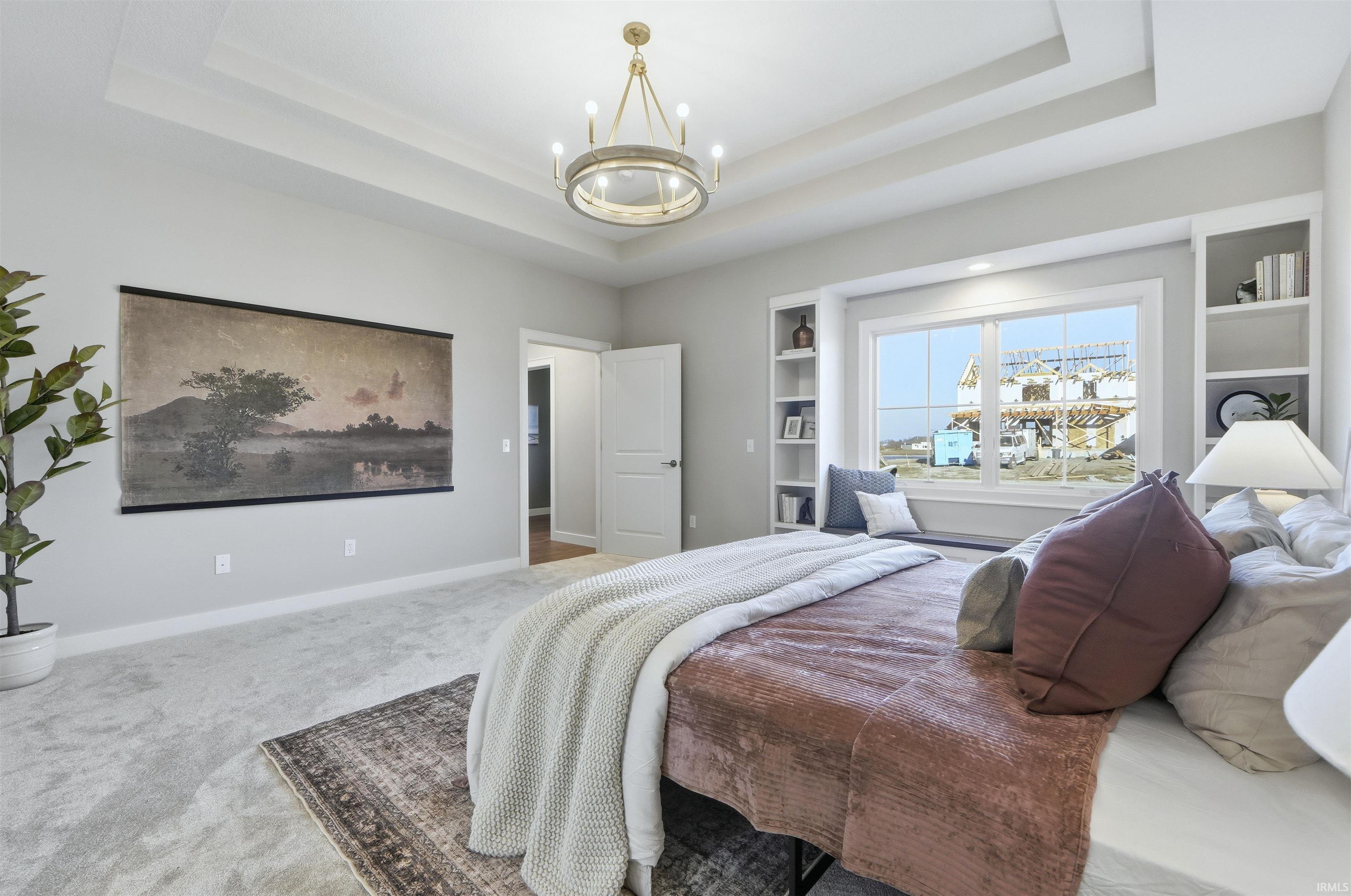 Bedroom with carpet floors and a chandelier
