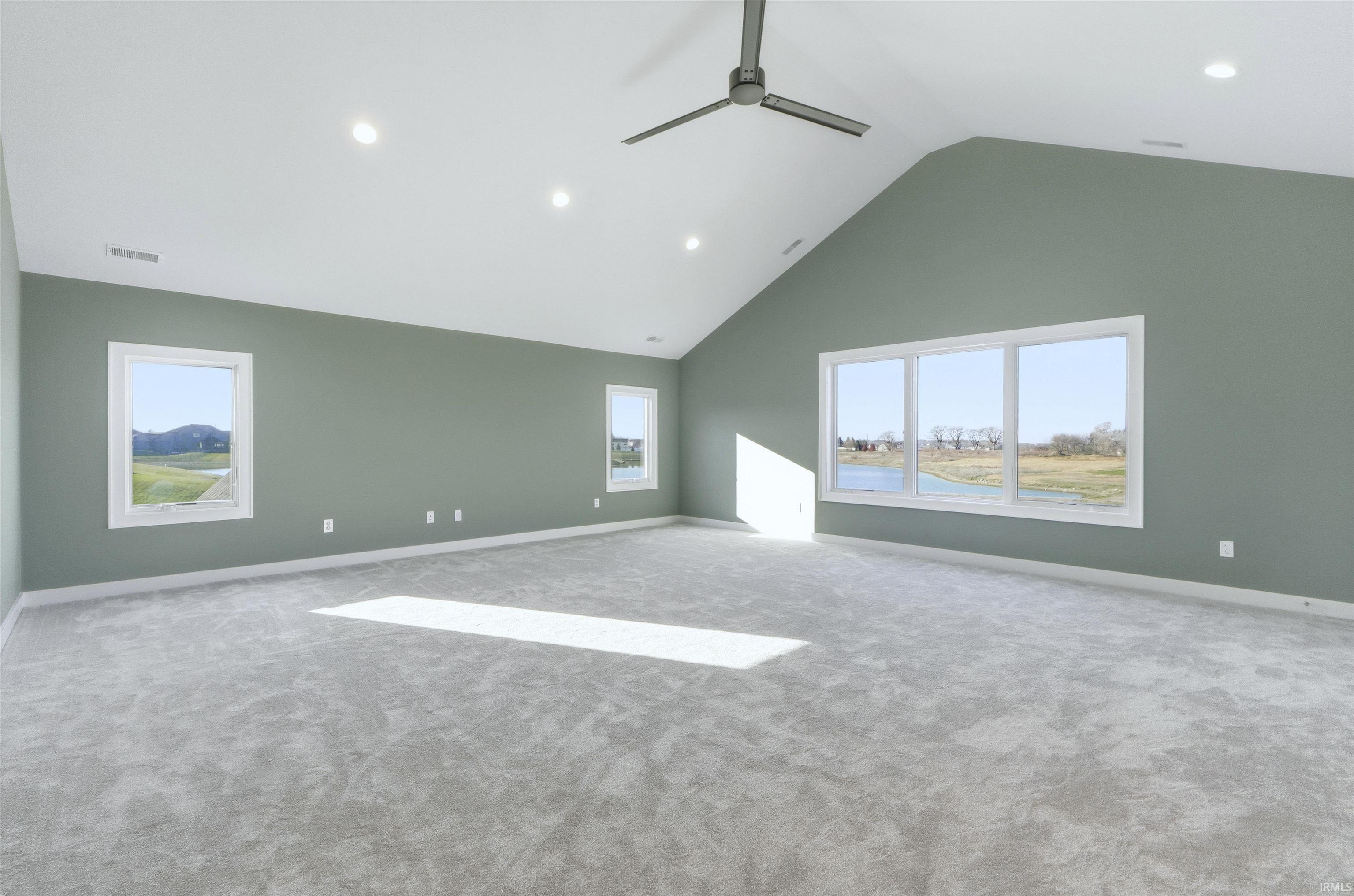 Unfurnished room featuring high vaulted ceiling, ceiling fan, recessed lighting, and carpet