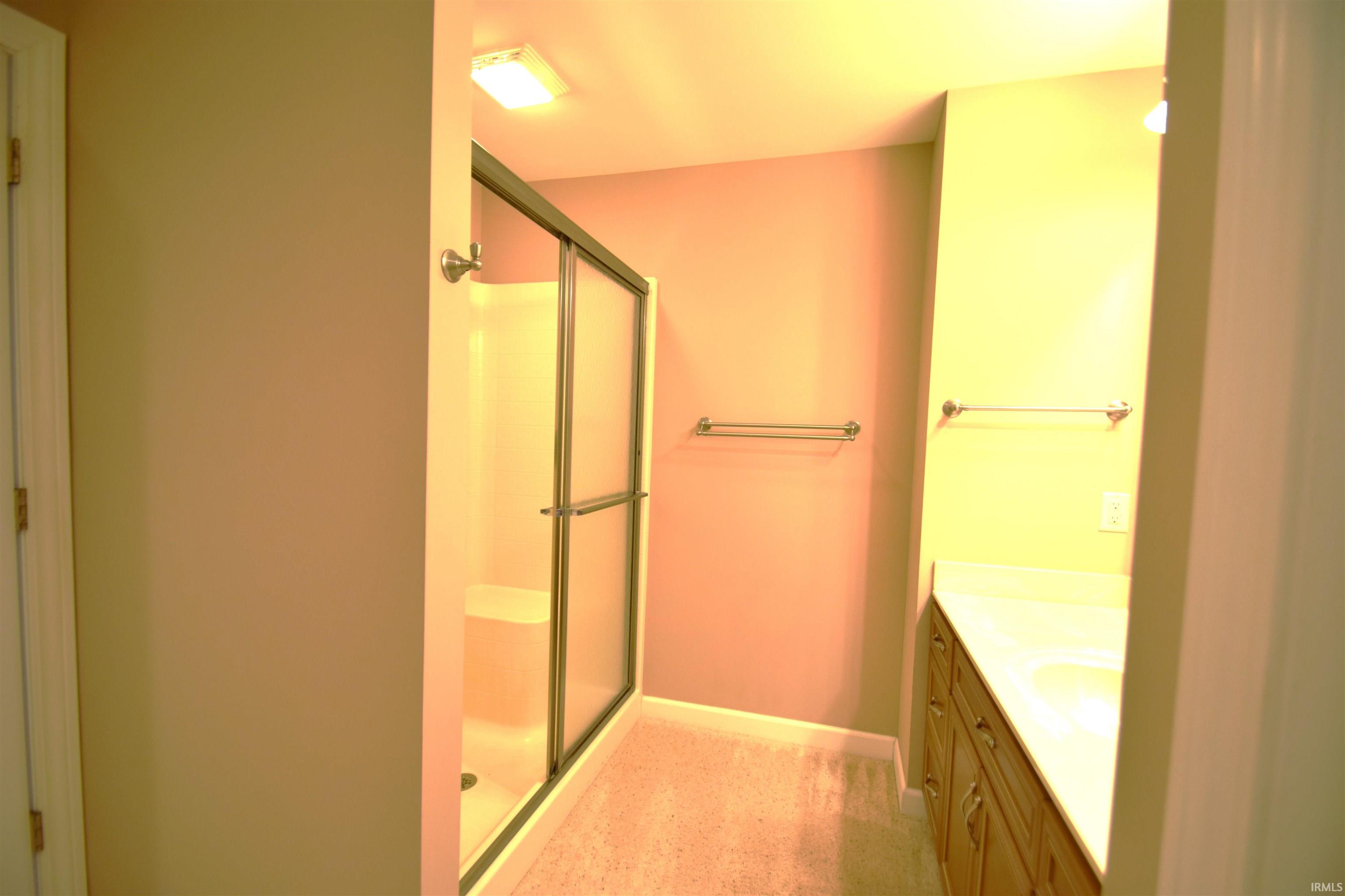 Bathroom with vanity and a stall shower