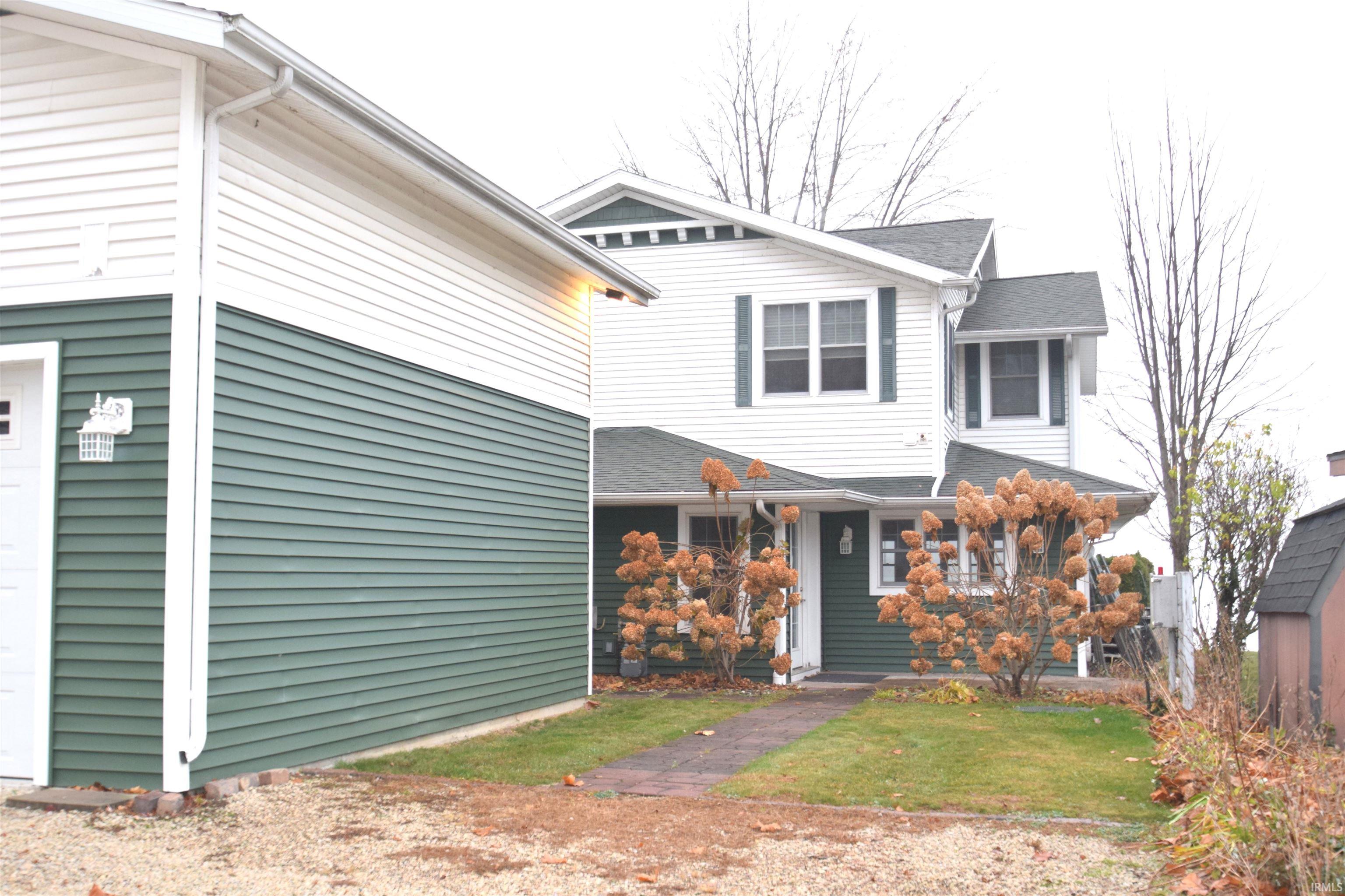 View of front of home with a garage and a front lawn