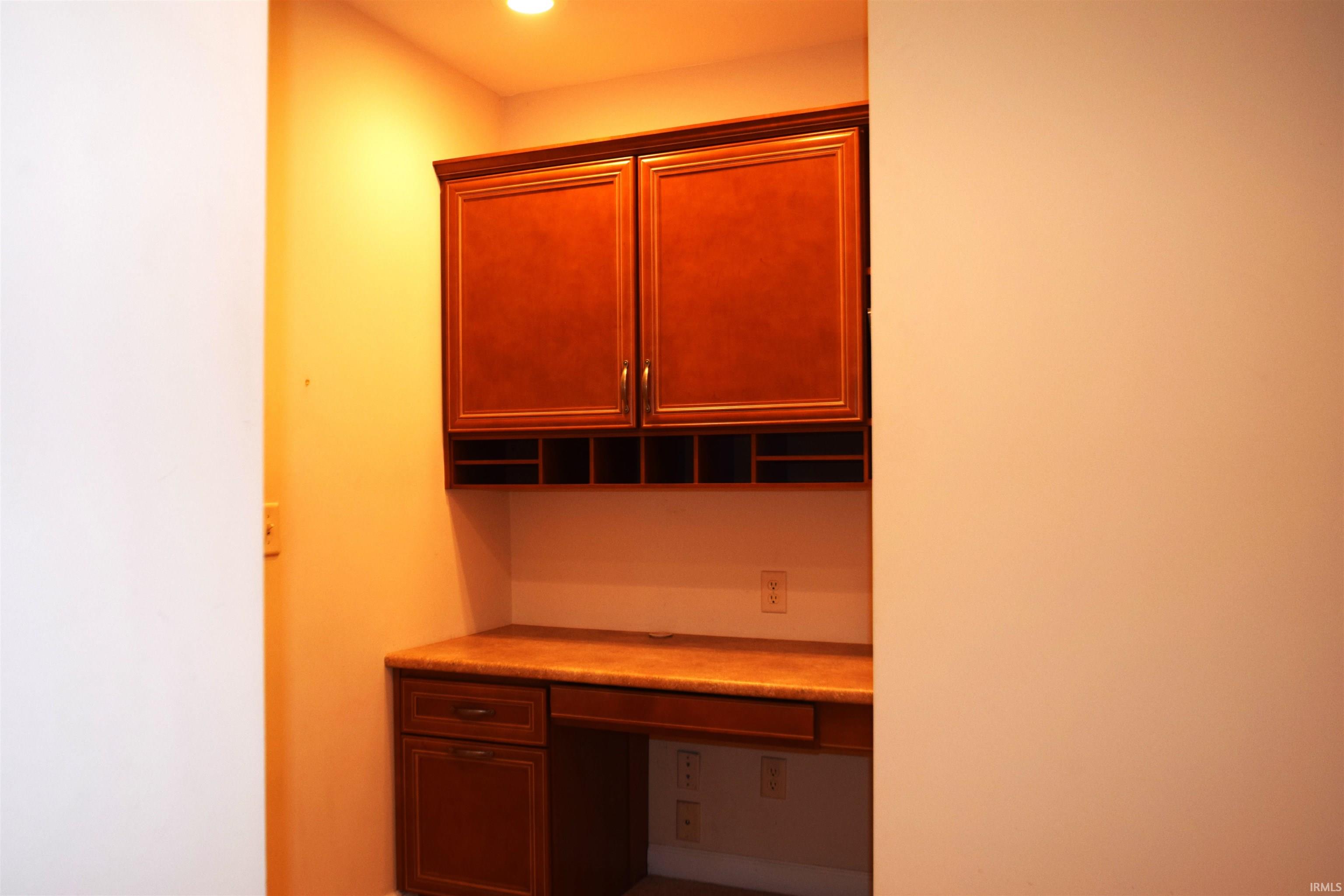 Unfurnished office featuring built in desk