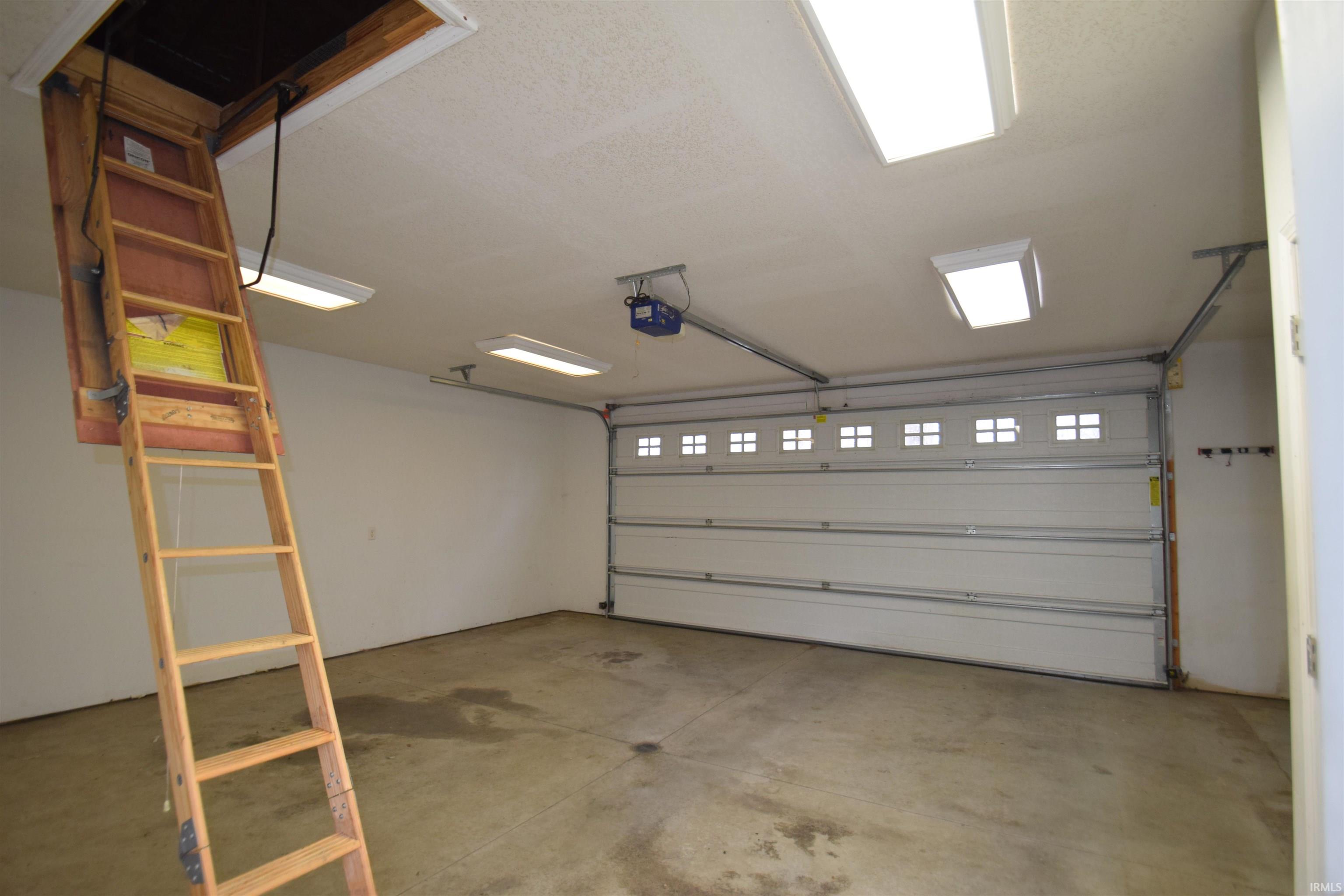 Garage featuring a garage door opener