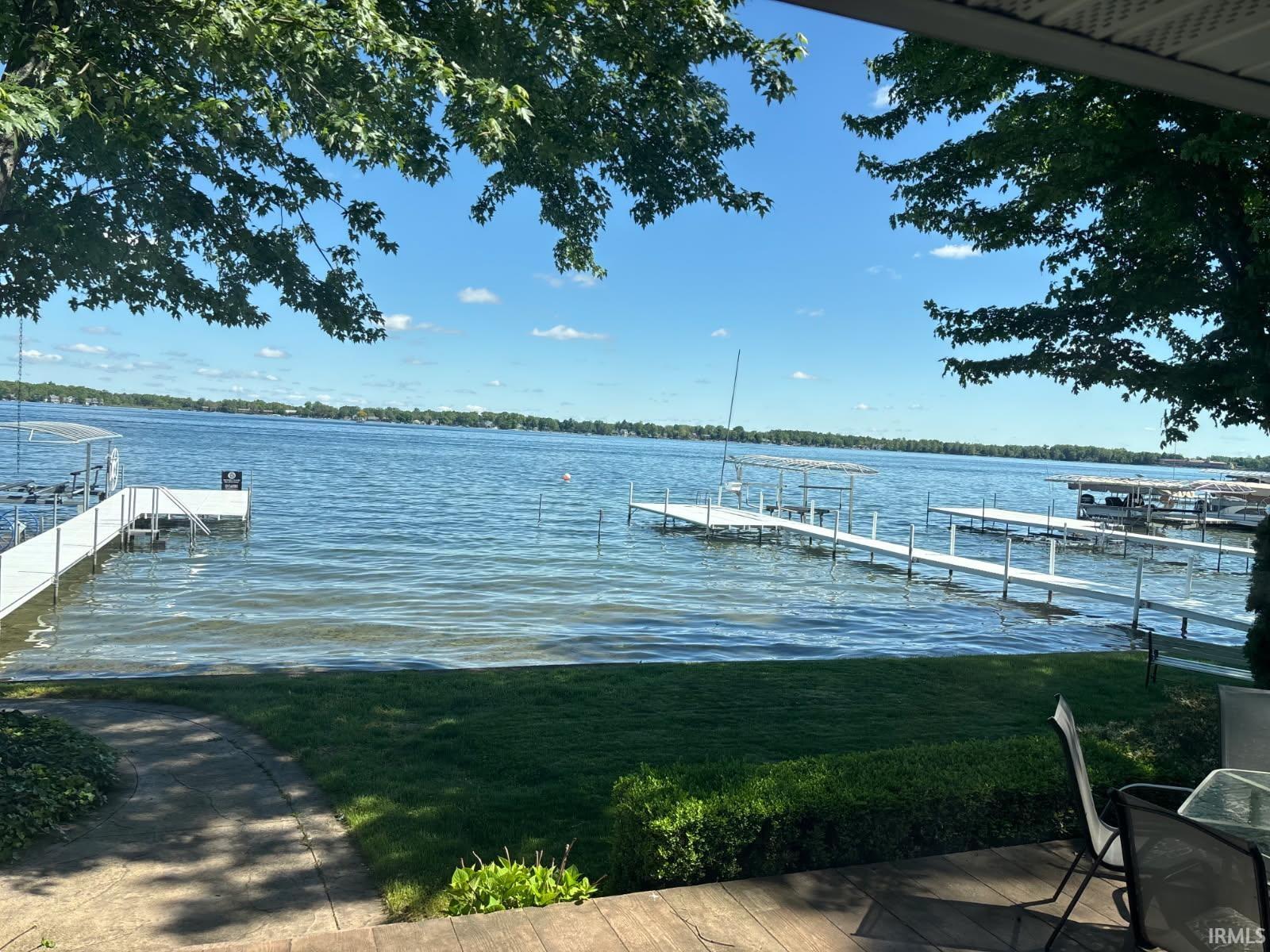 Dock featuring a water view and a yard
