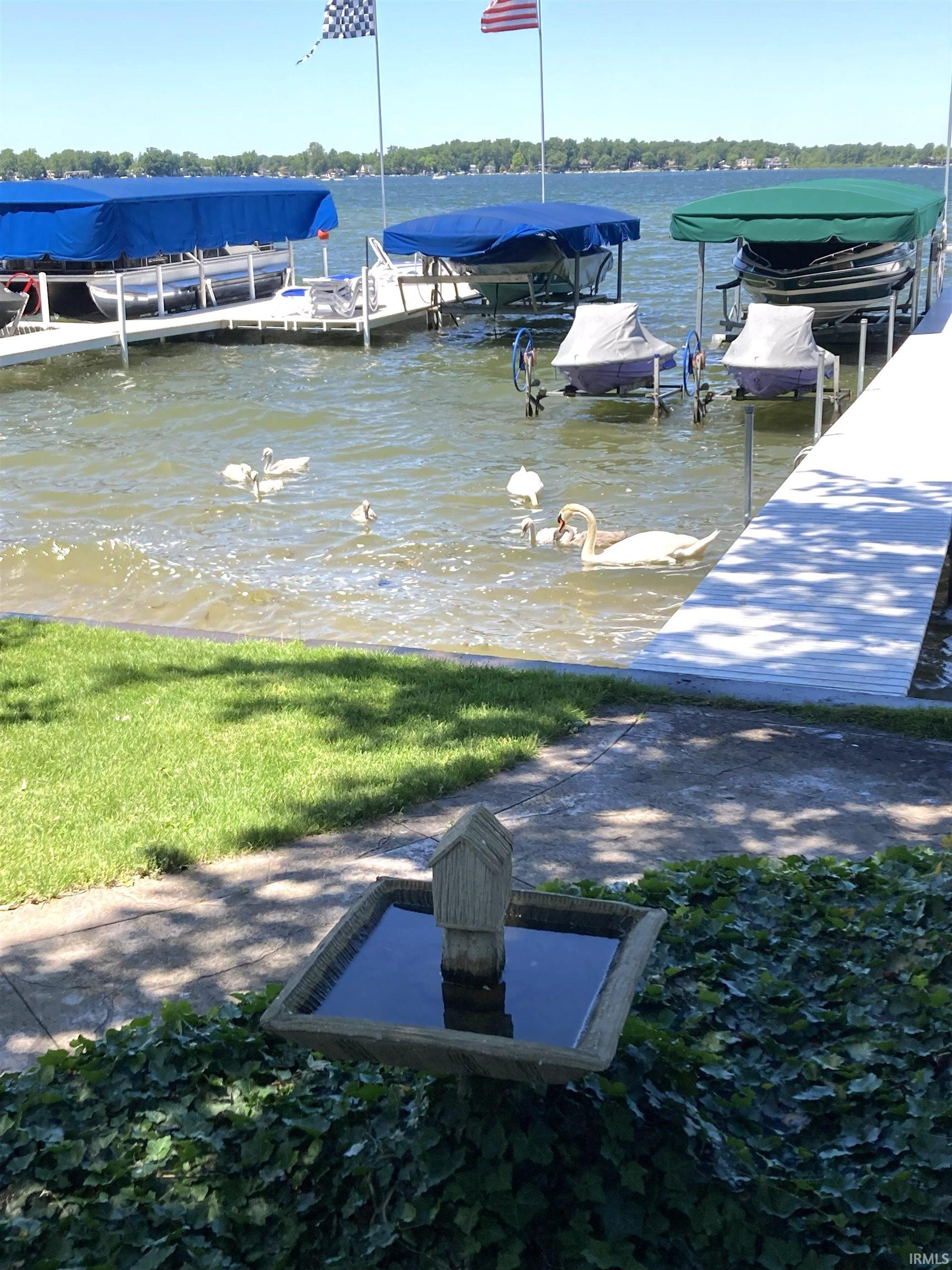 Dock area featuring a water view and boat lift