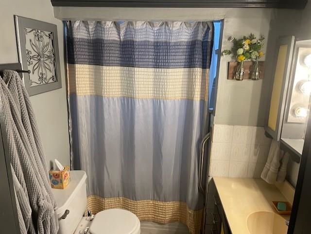 Bathroom featuring vanity and toilet