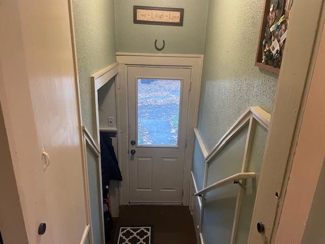 Doorway to outside with a textured wall