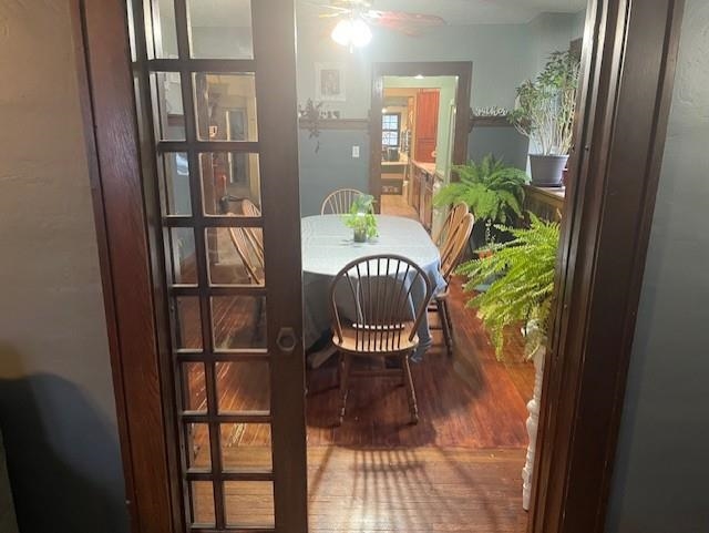 Dining room featuring ceiling fan and wood finished floors