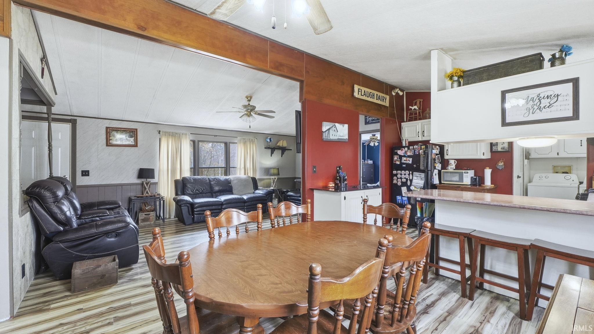 Dining area with ceiling fan, light wood-style flooring, and washer / clothes dryer