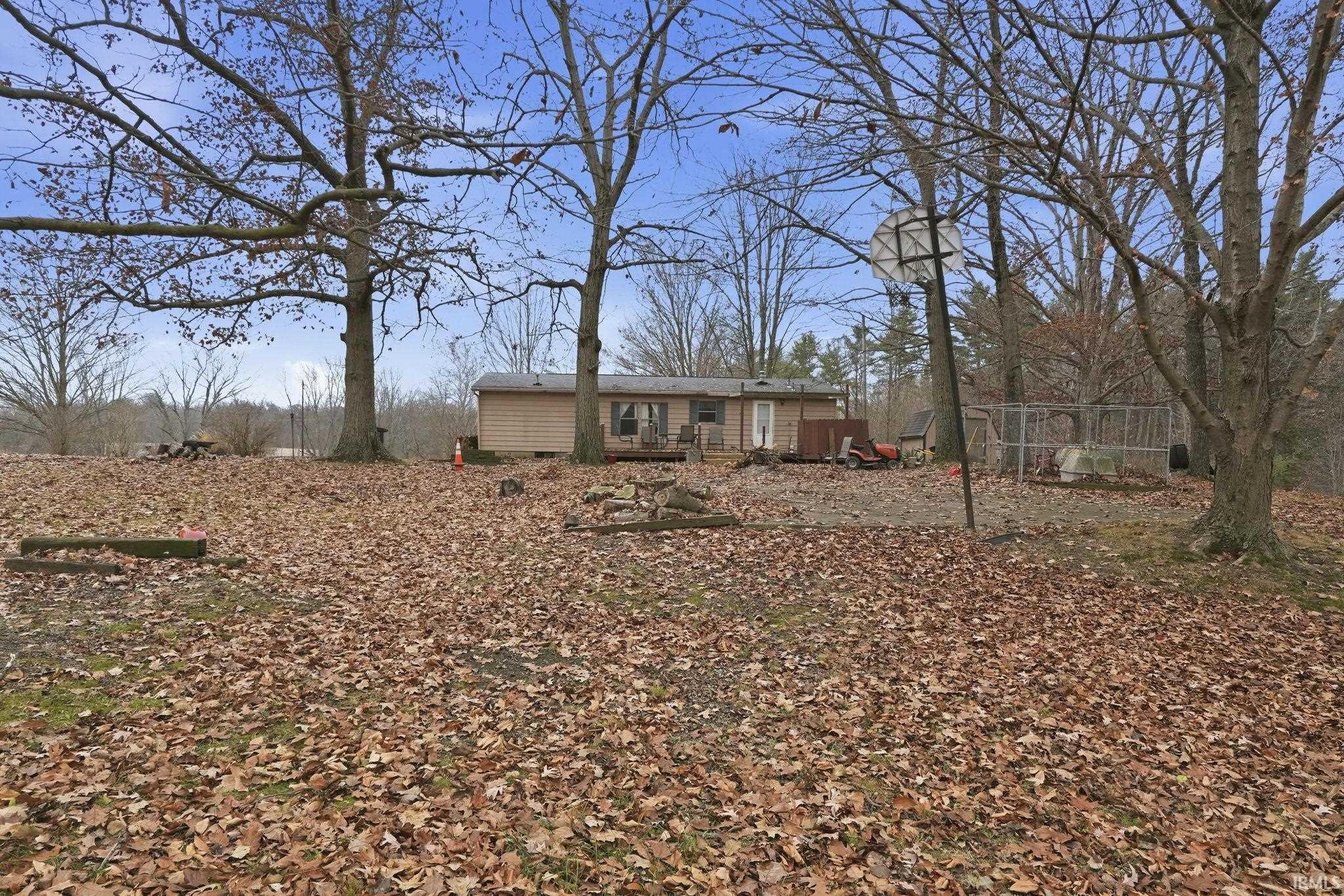 Back yard of home featuring an outbuilding