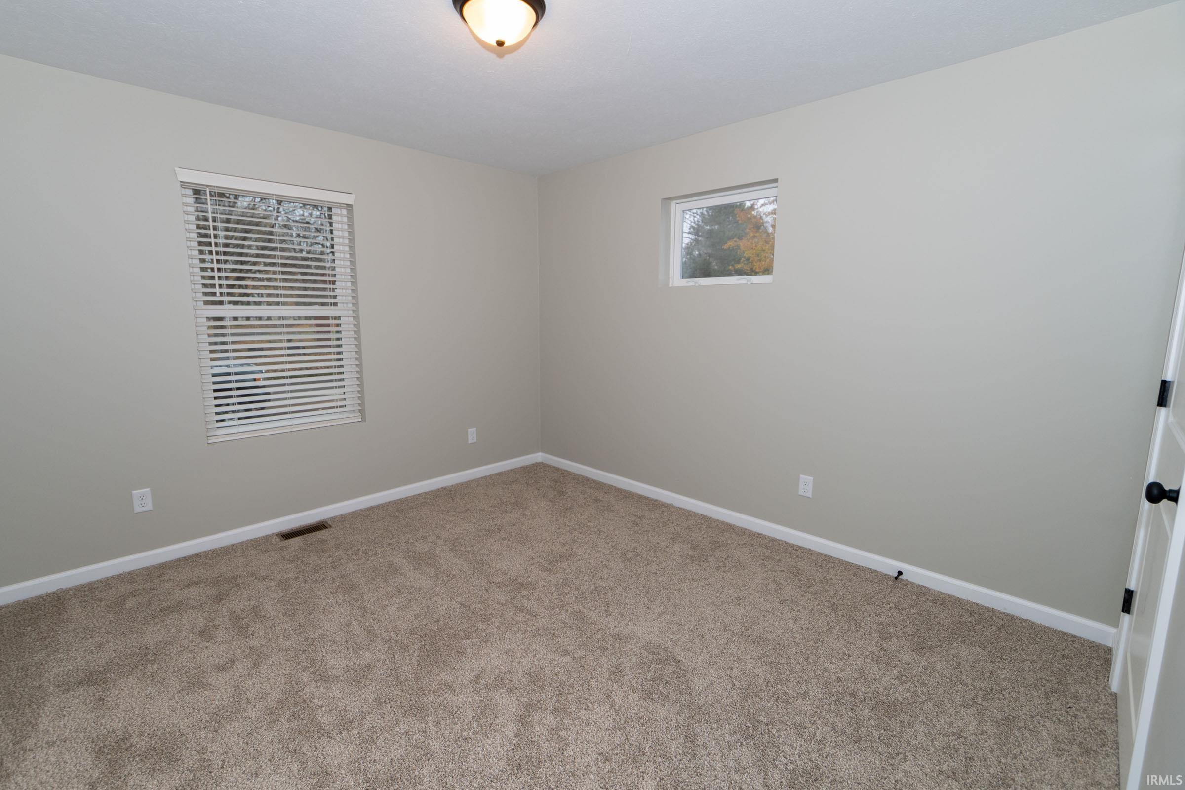 Unfurnished room with baseboards and carpet floors