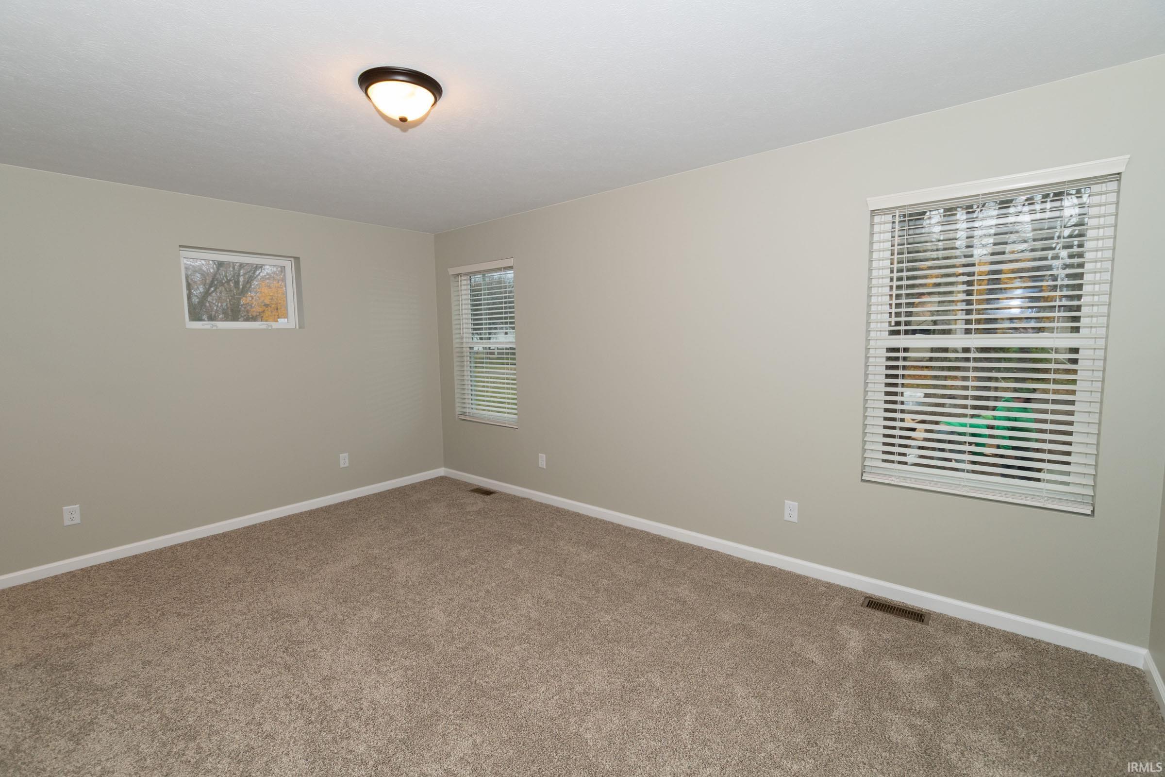 Unfurnished room featuring baseboards and carpet