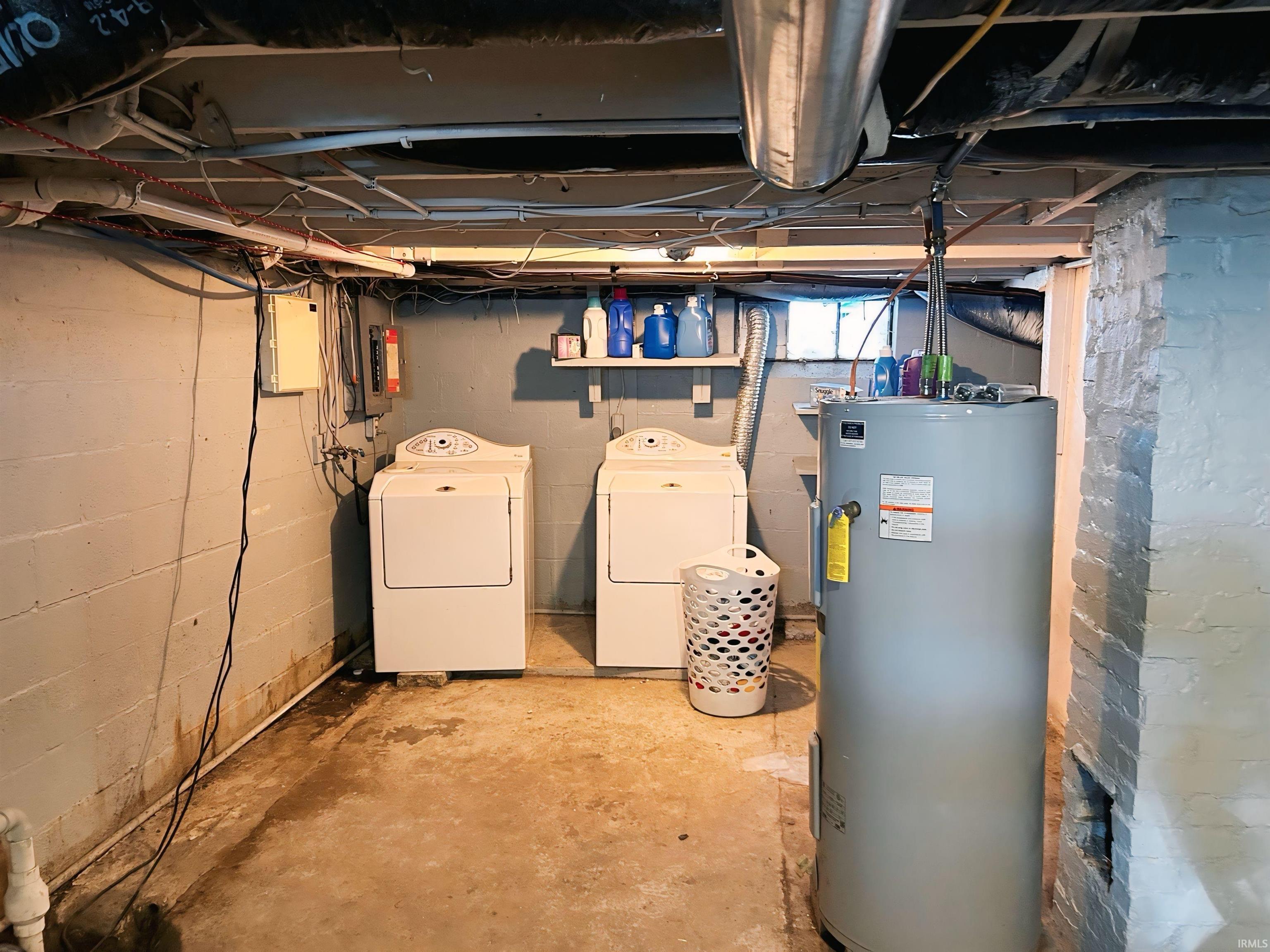 Unfinished basement with water heater and separate washer and dryer