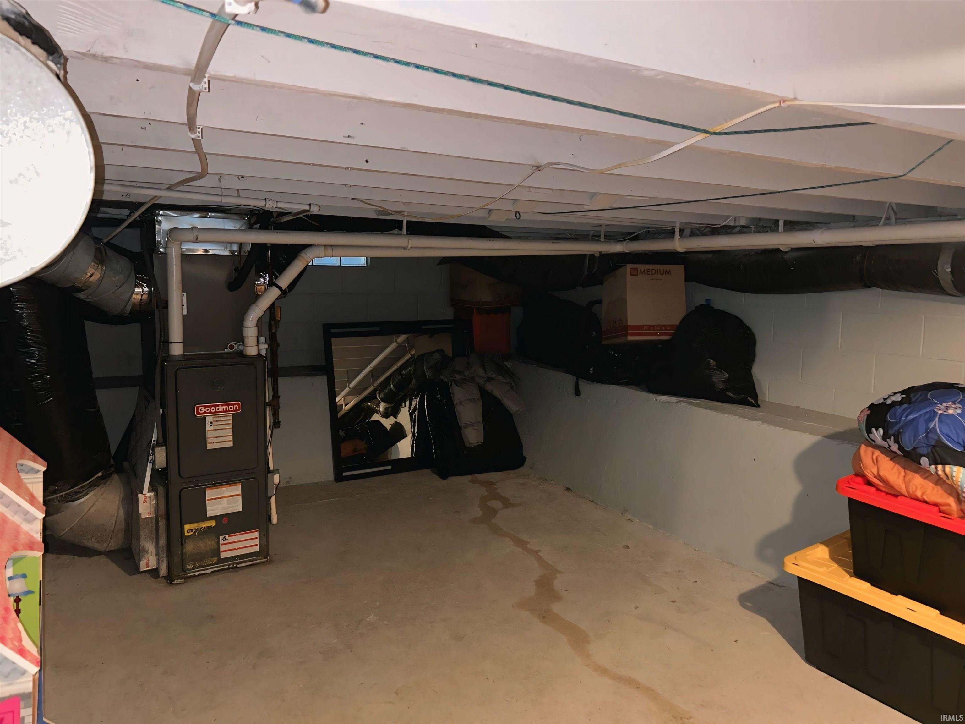 Unfinished basement featuring heating unit