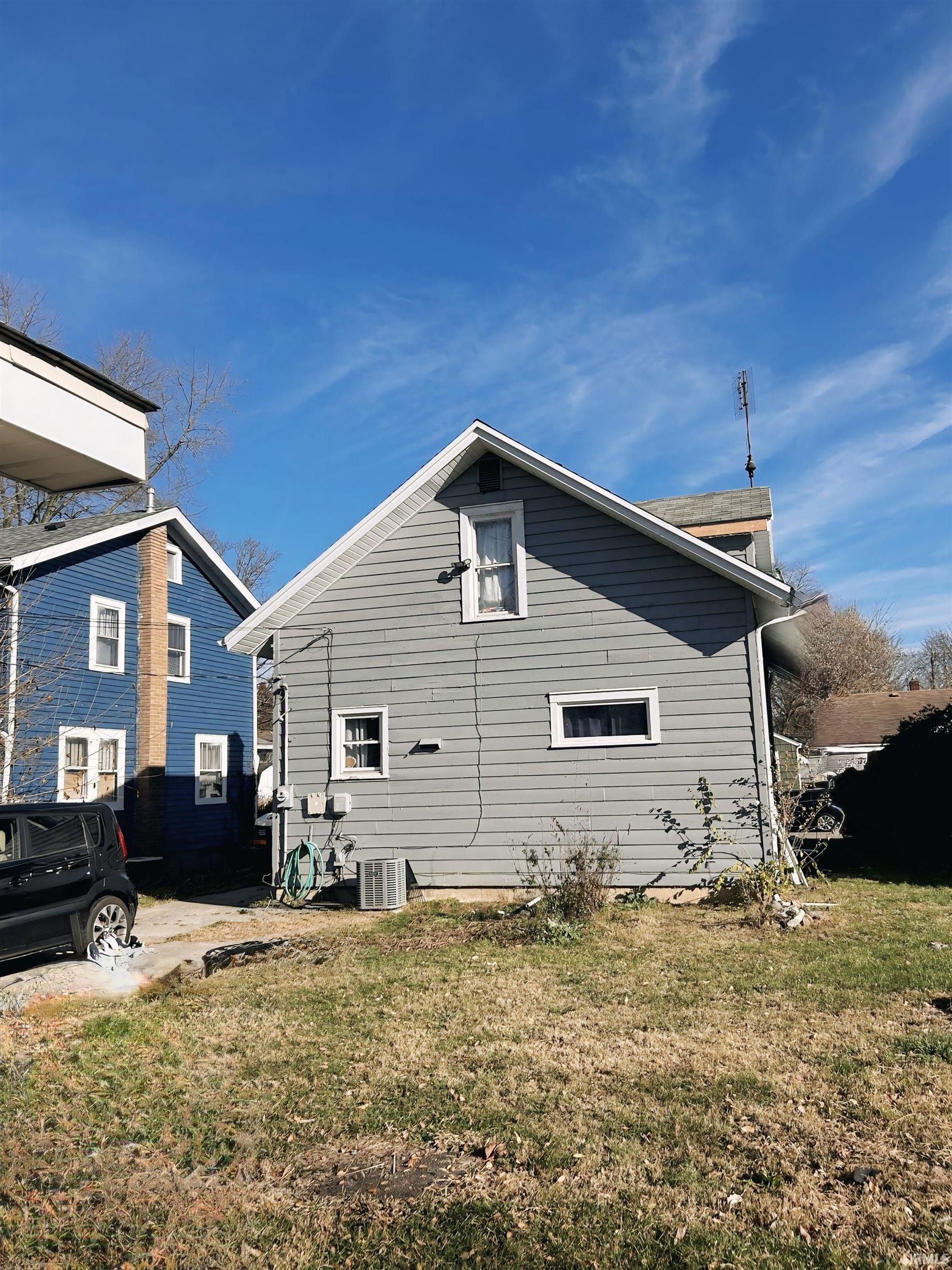 View of property exterior featuring a yard