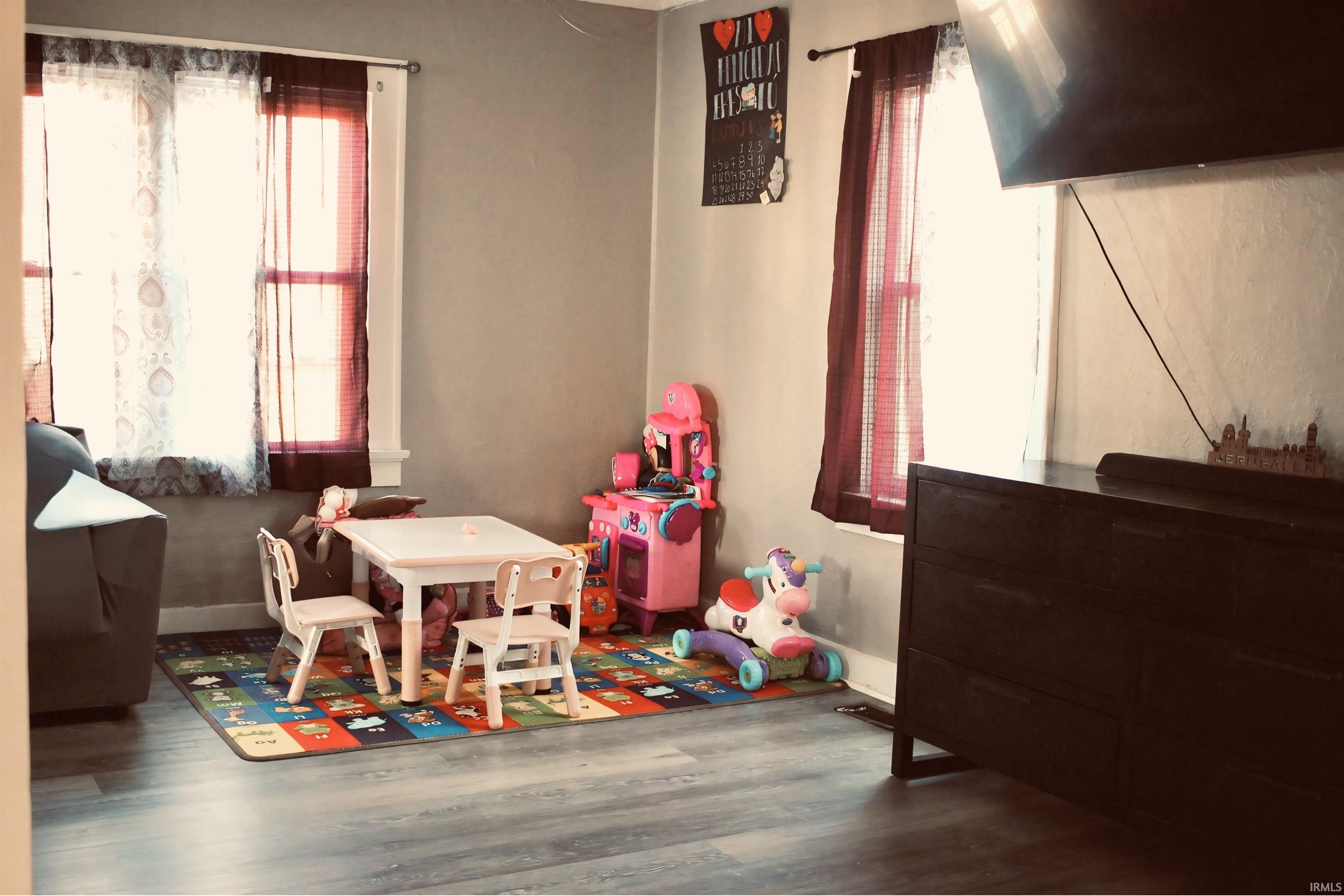 Game room with wood finished floors and baseboards