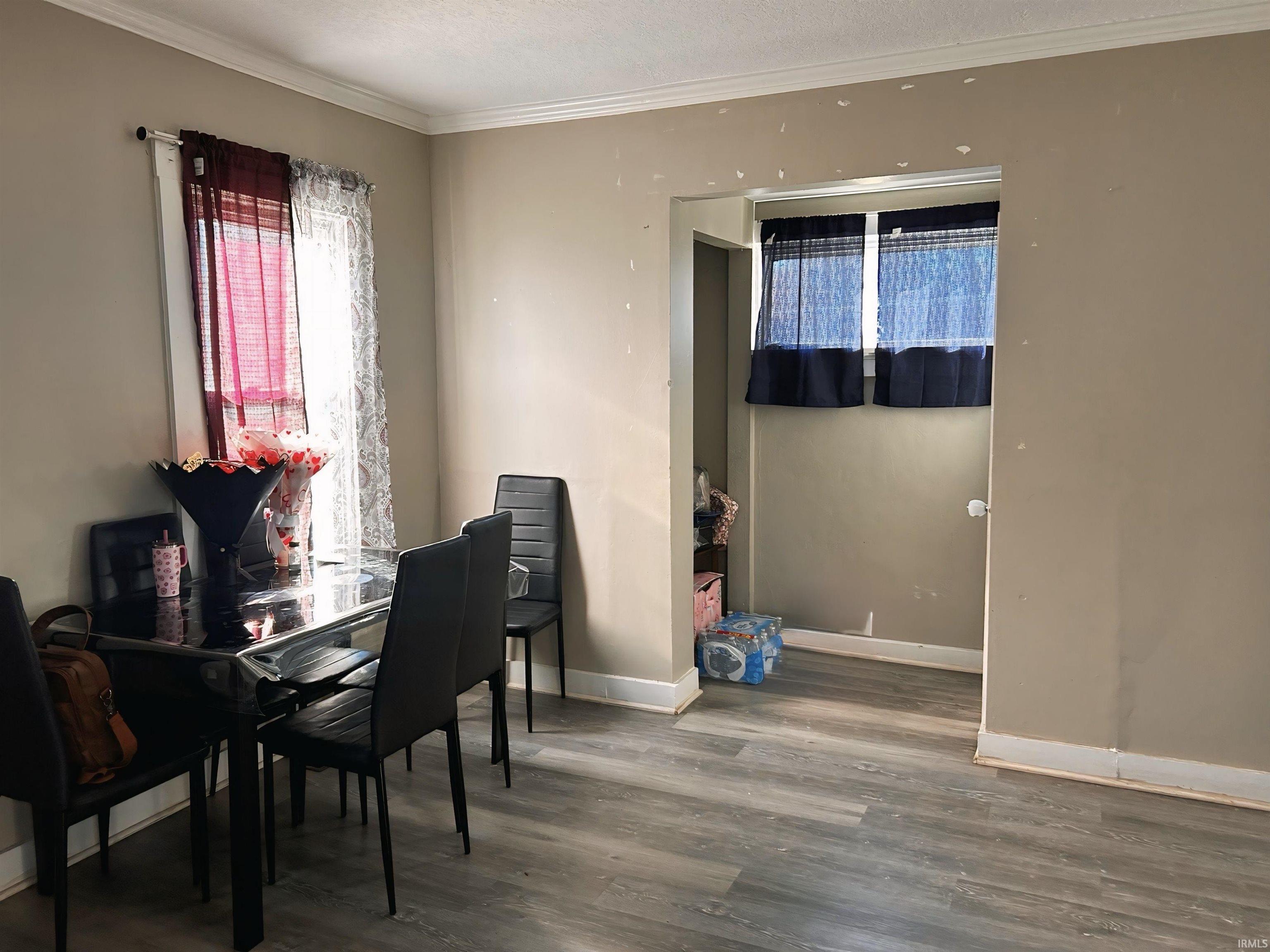 Dining room featuring crown molding and wood finished floors