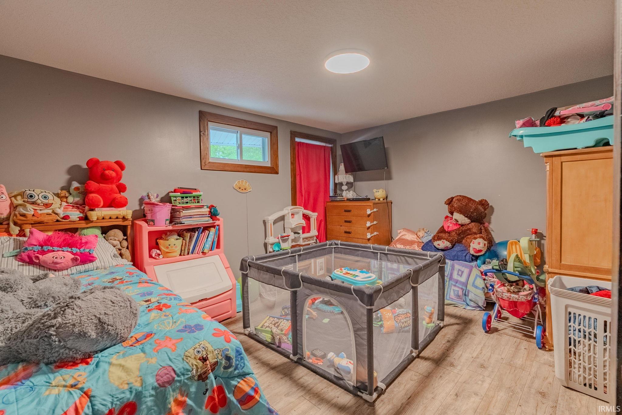 Bedroom with light laminate floors