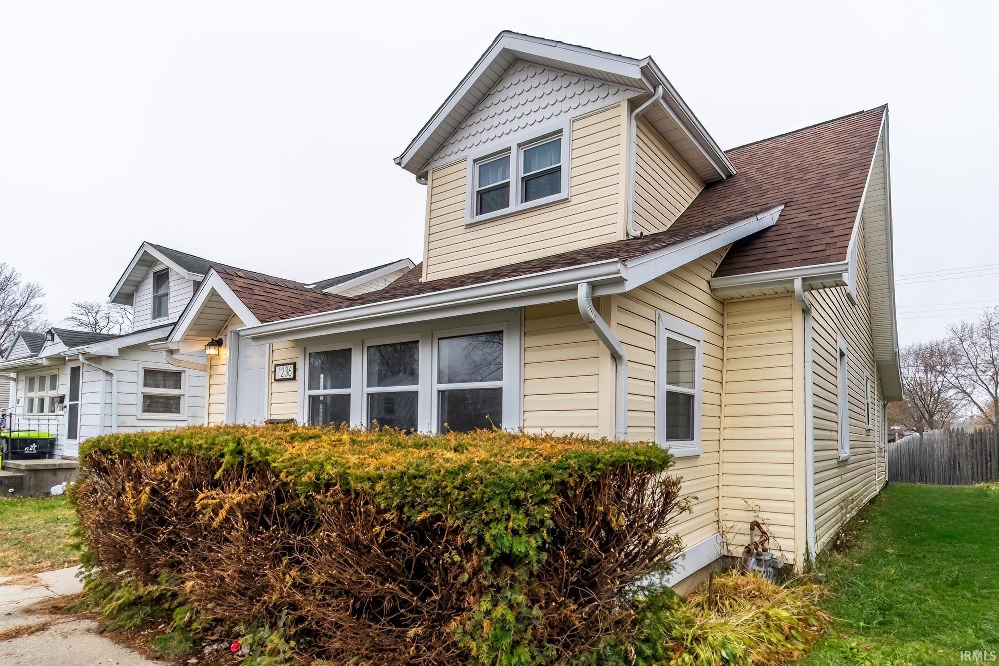 View of property exterior with a shingled roof