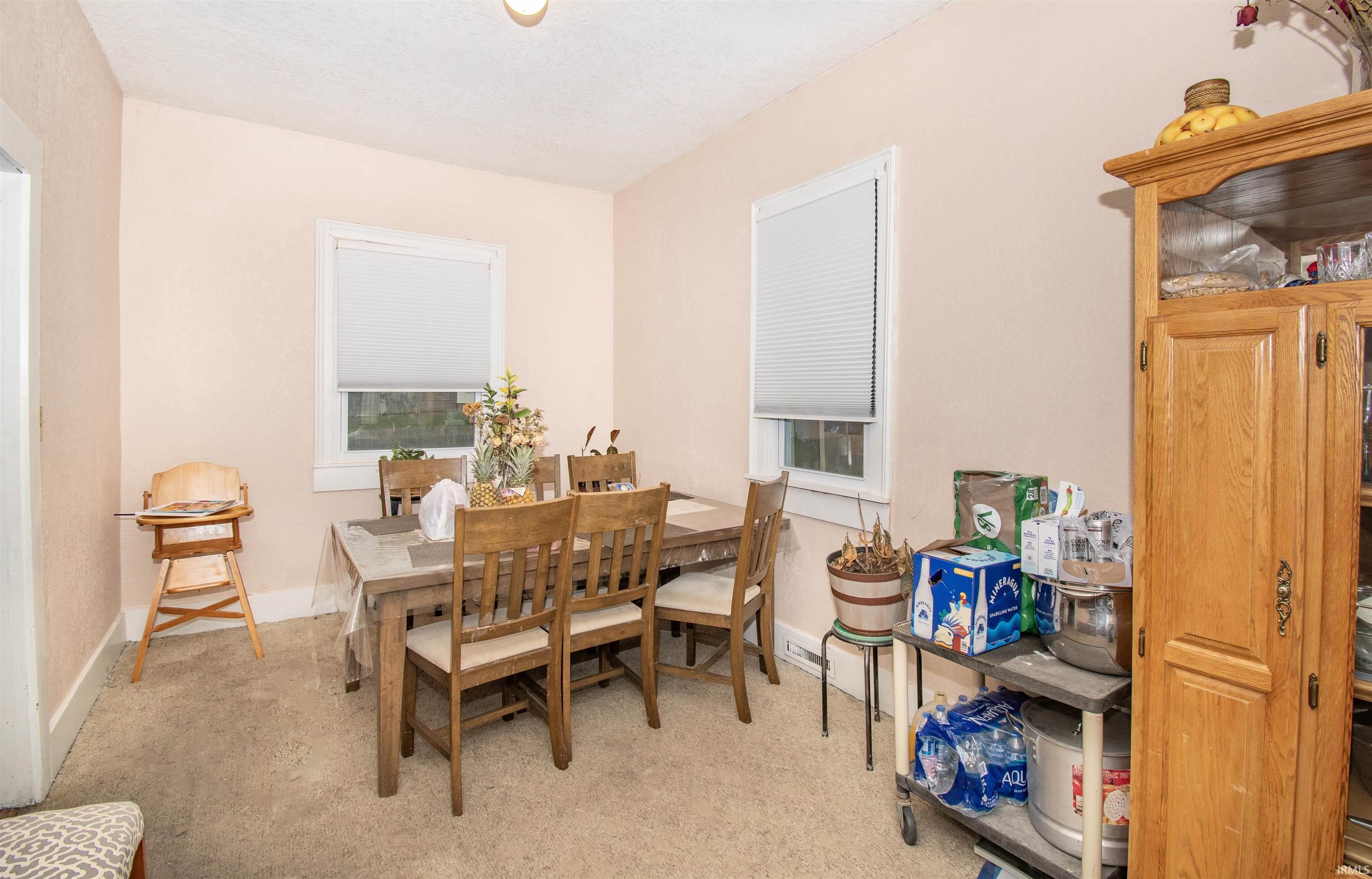 Dining area featuring baseboards and light colored carpet