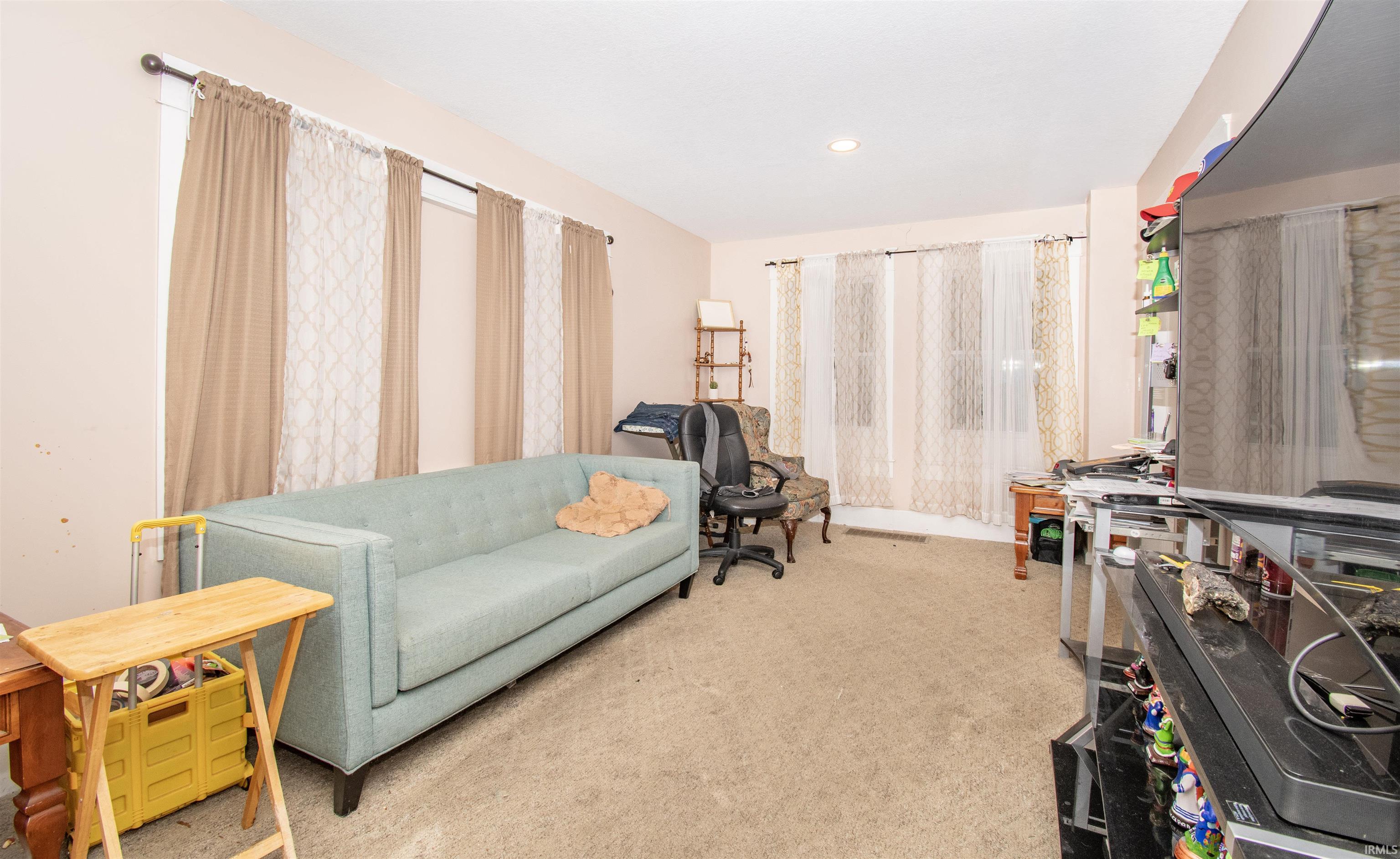 Living area with light colored carpet