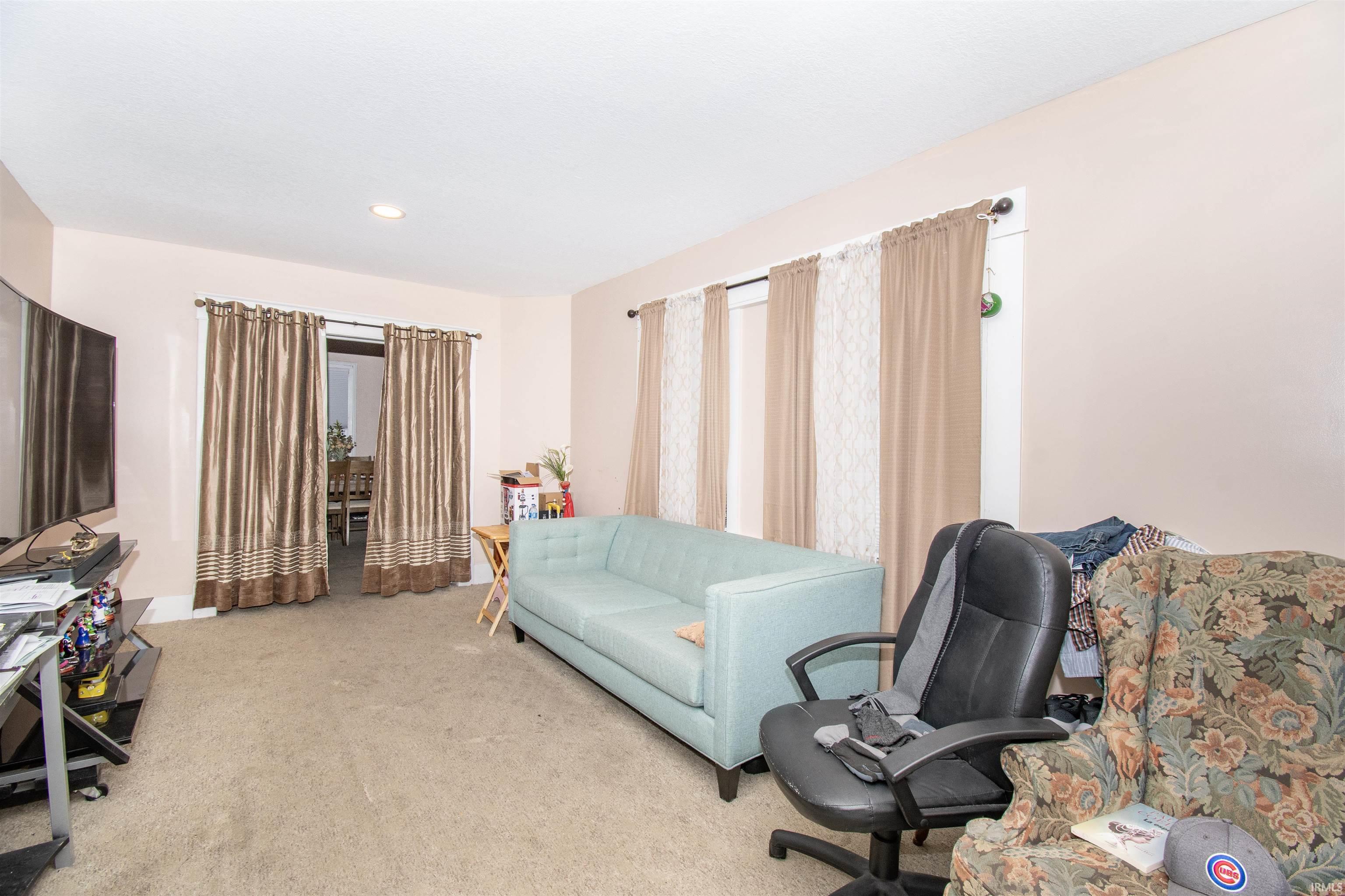 Home office featuring light carpet