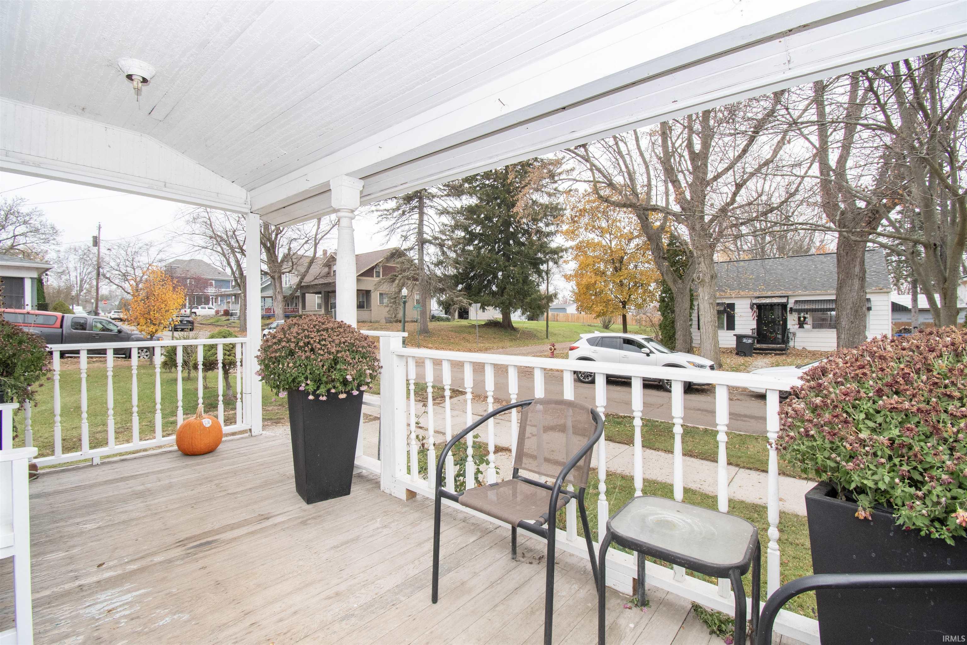 Wooden deck with a residential view and a yard