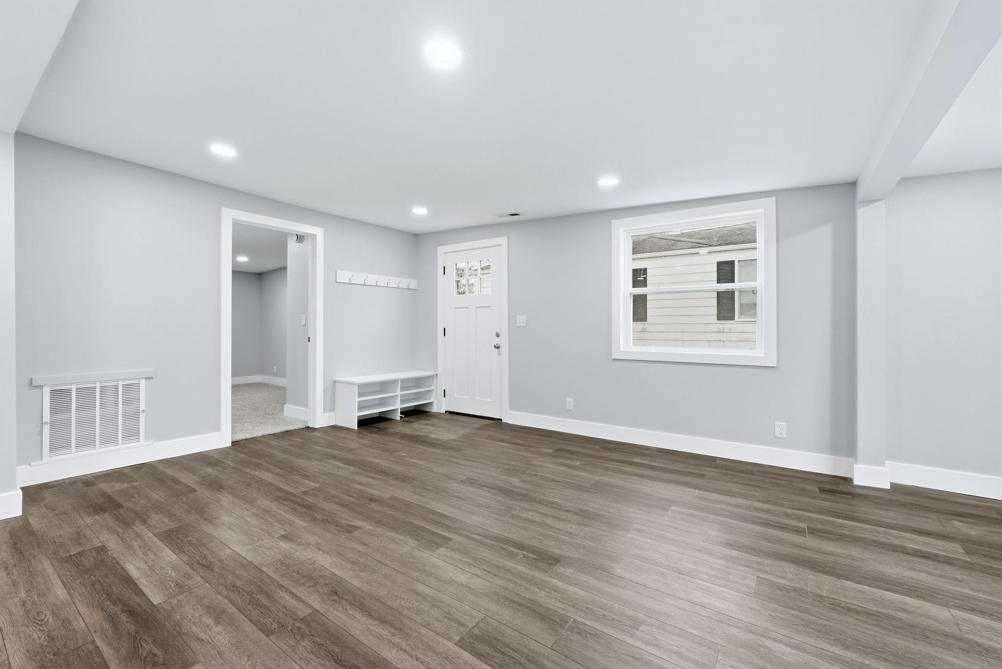 Unfurnished living room featuring wood finished floors and recessed lighting