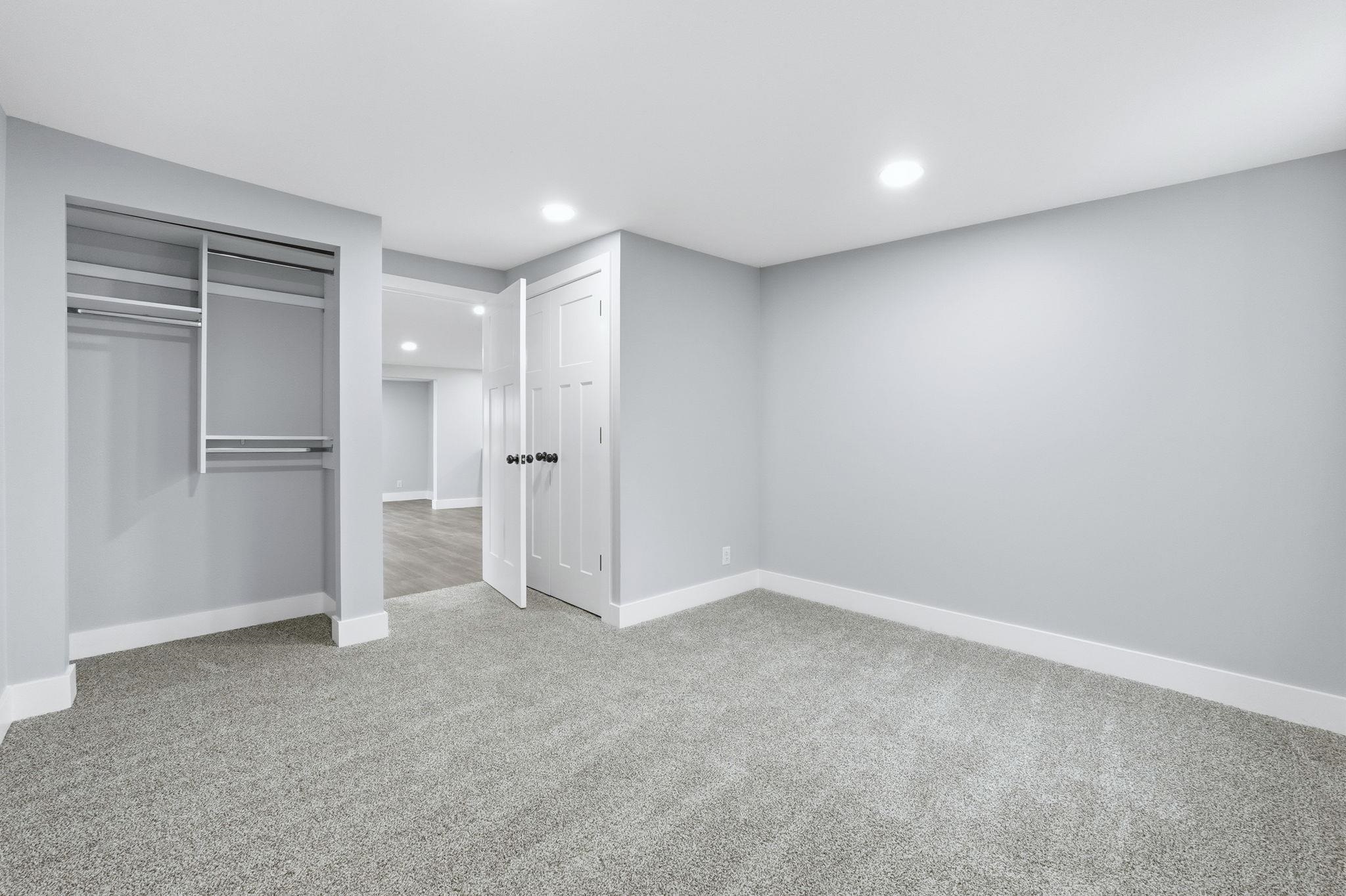 Unfurnished bedroom with recessed lighting and light carpet